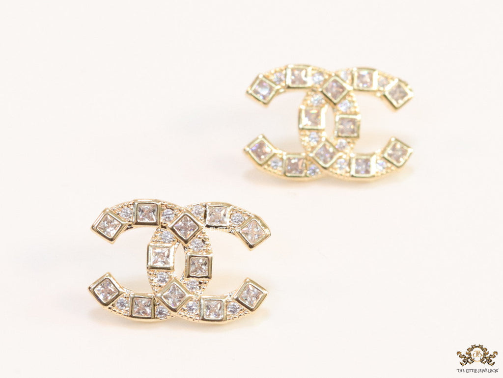 Golden twin C motif studs with fancy cut cz