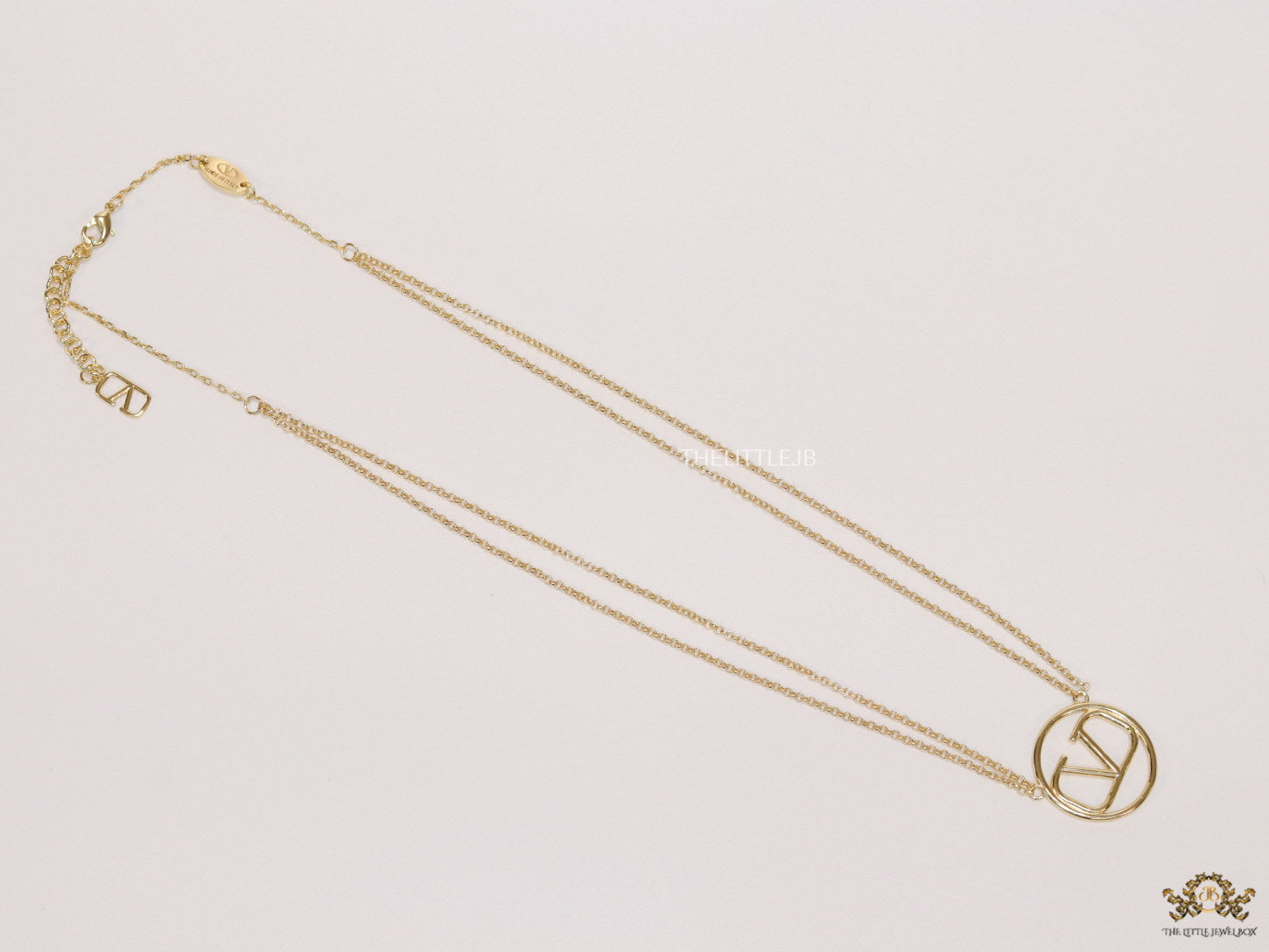 Dual chain golden necklace with alphabet pendant