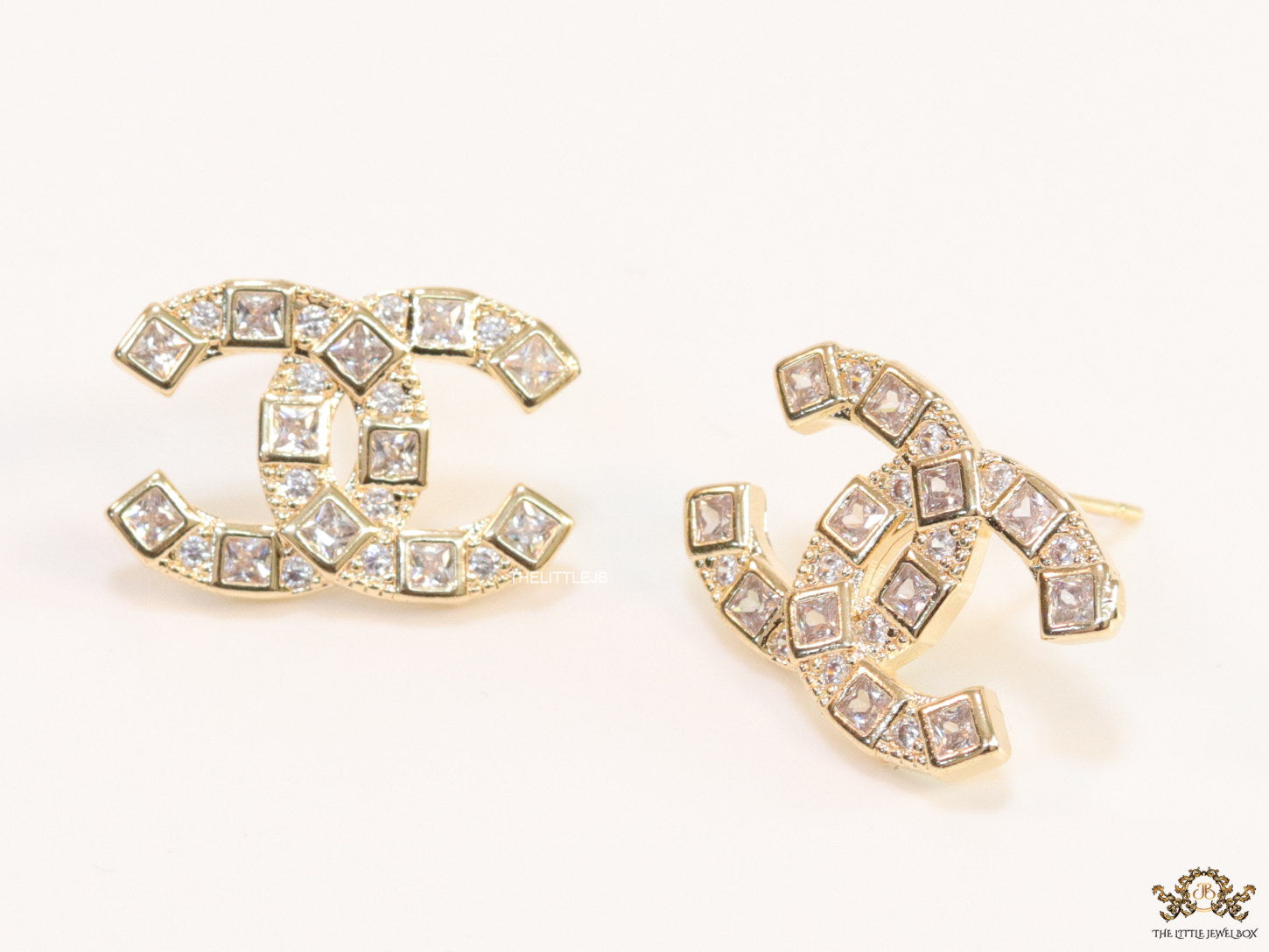 Golden twin C motif studs with fancy cut cz