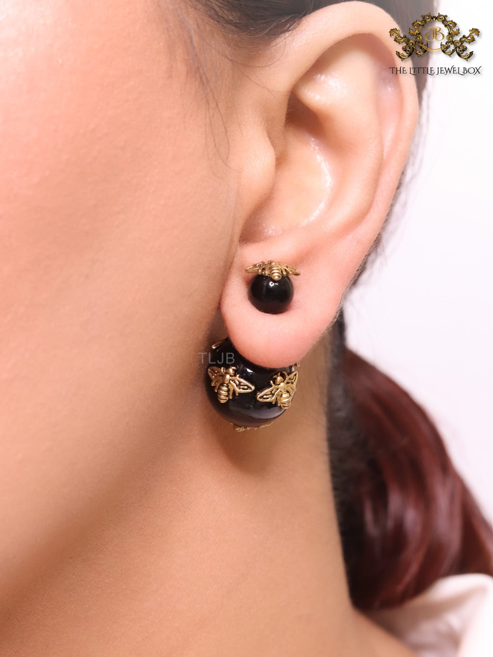Rustic dragonfly on black pearls in gold