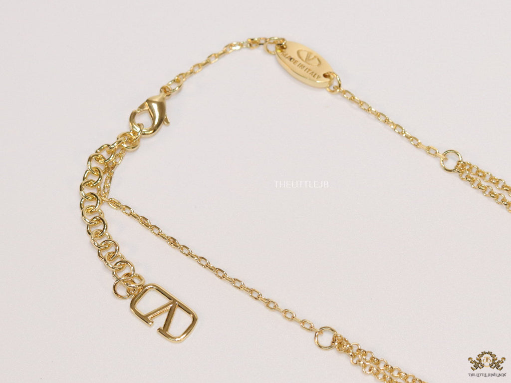 Dual chain golden necklace with alphabet pendant