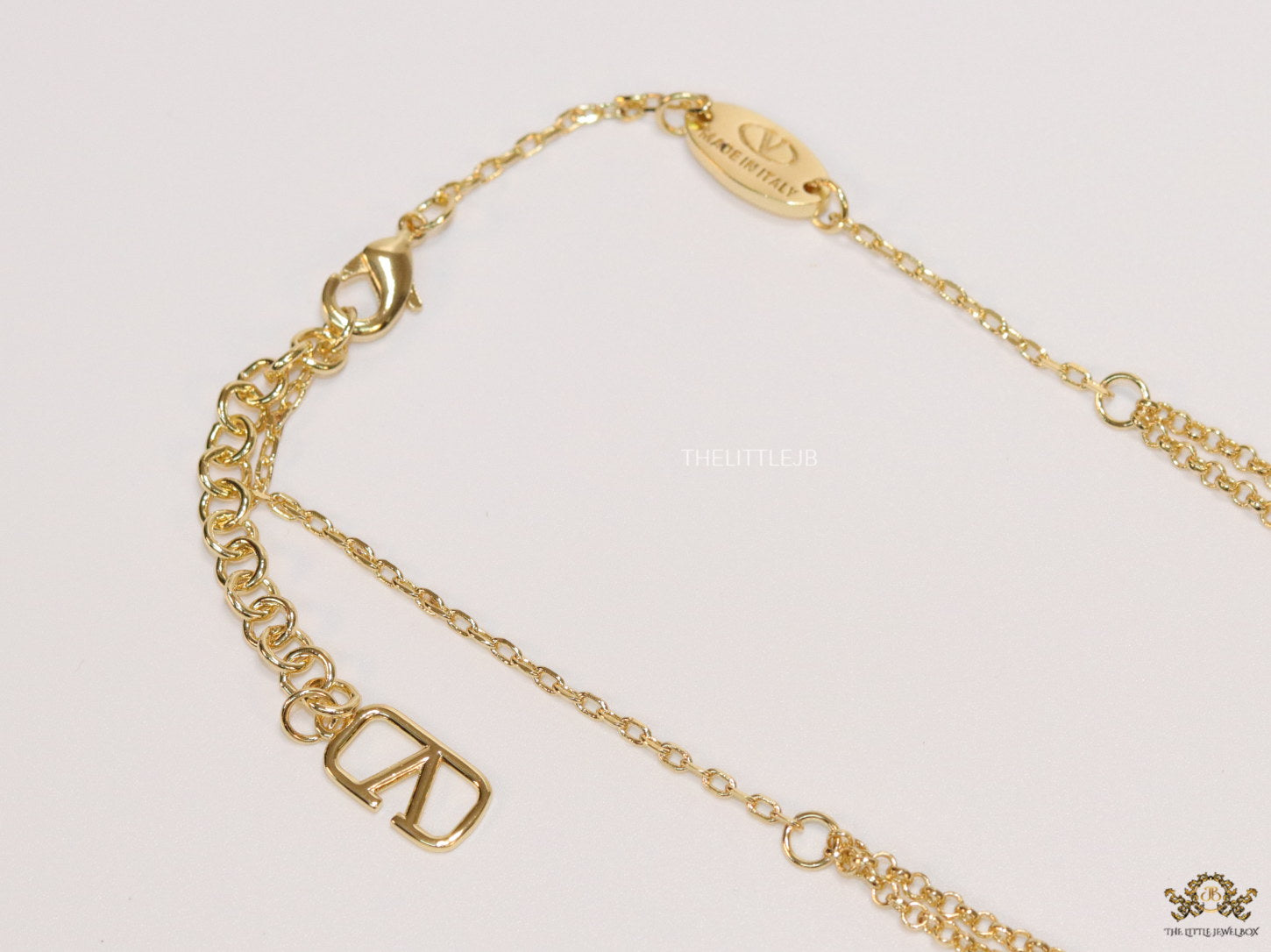 Dual chain golden necklace with alphabet pendant