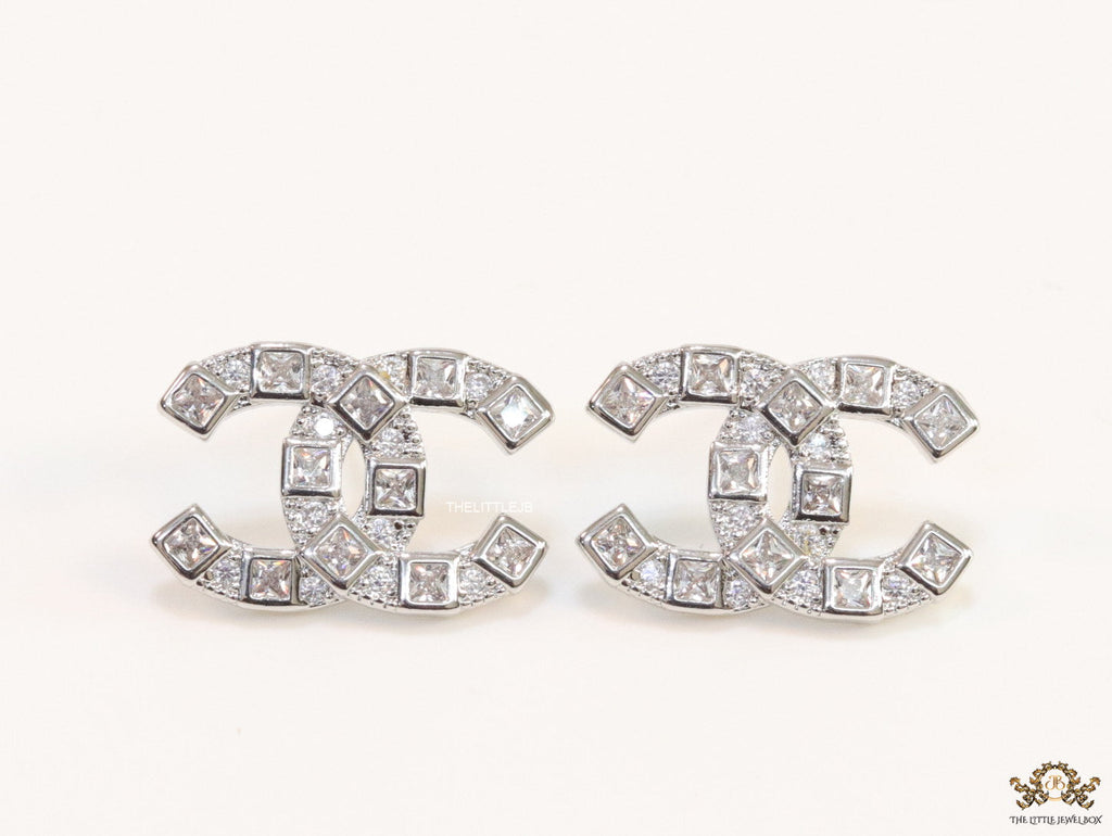 Platinum plated twin C motif studs with fancy cut cz