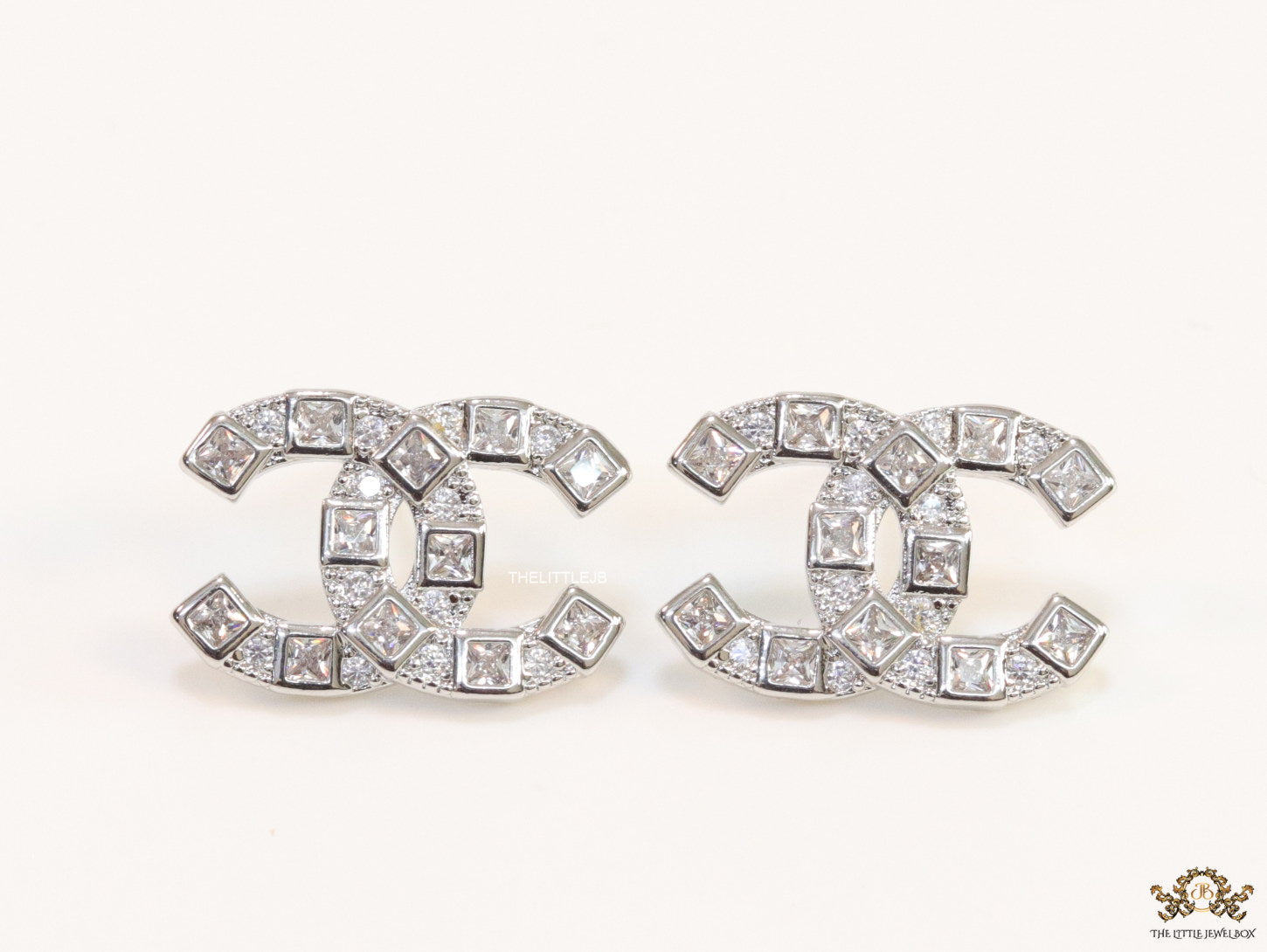 Platinum plated twin C motif studs with fancy cut cz