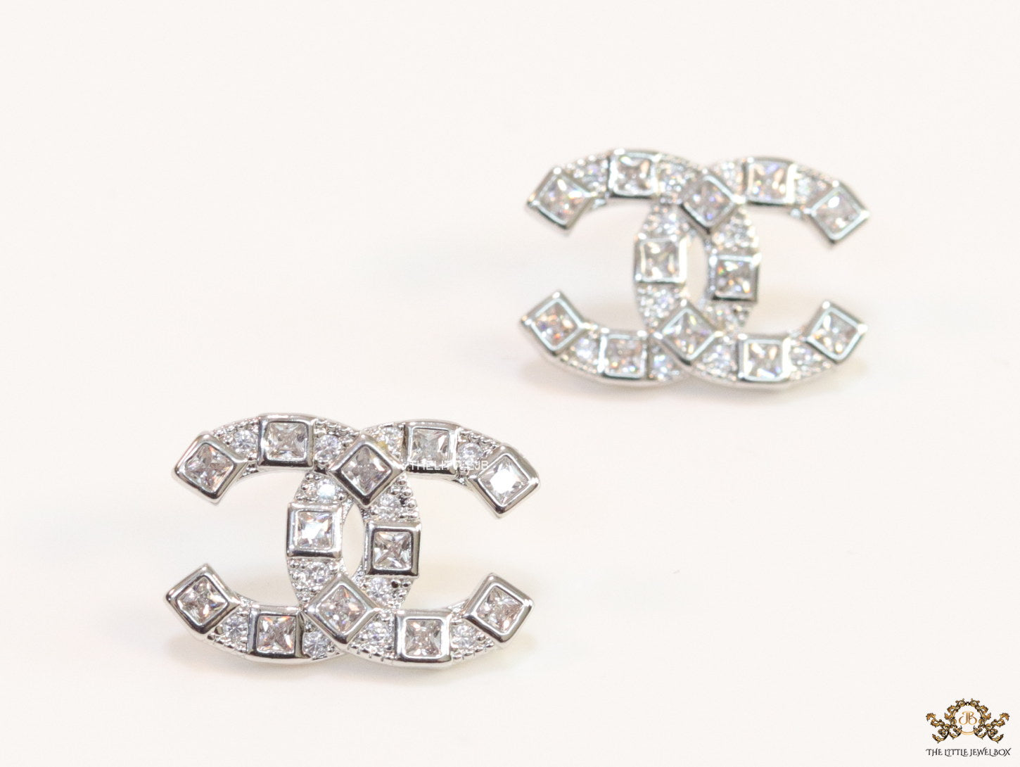 Platinum plated twin C motif studs with fancy cut cz