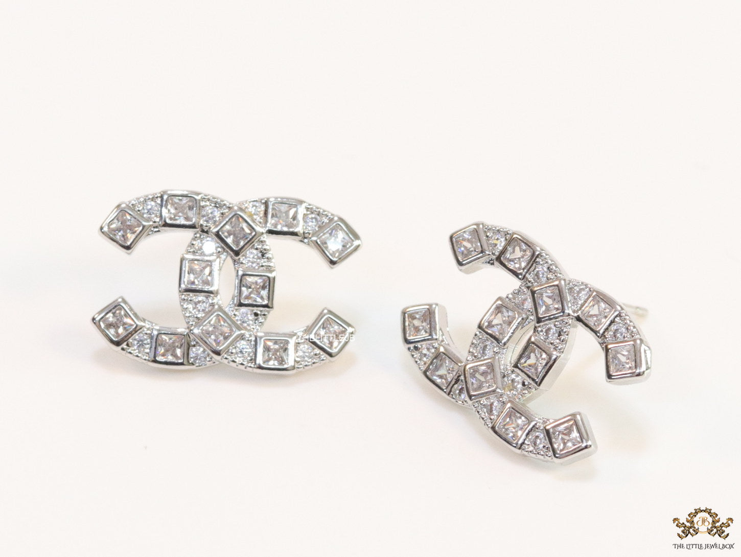 Platinum plated twin C motif studs with fancy cut cz
