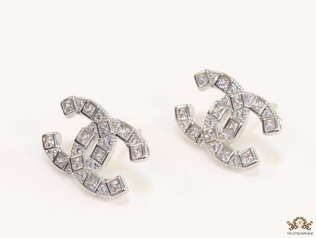 Platinum plated twin C motif studs with fancy cut cz