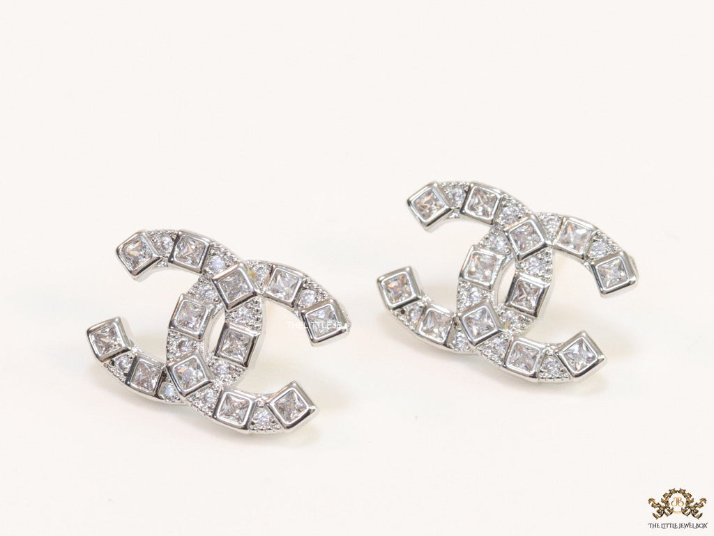 Platinum plated twin C motif studs with fancy cut cz