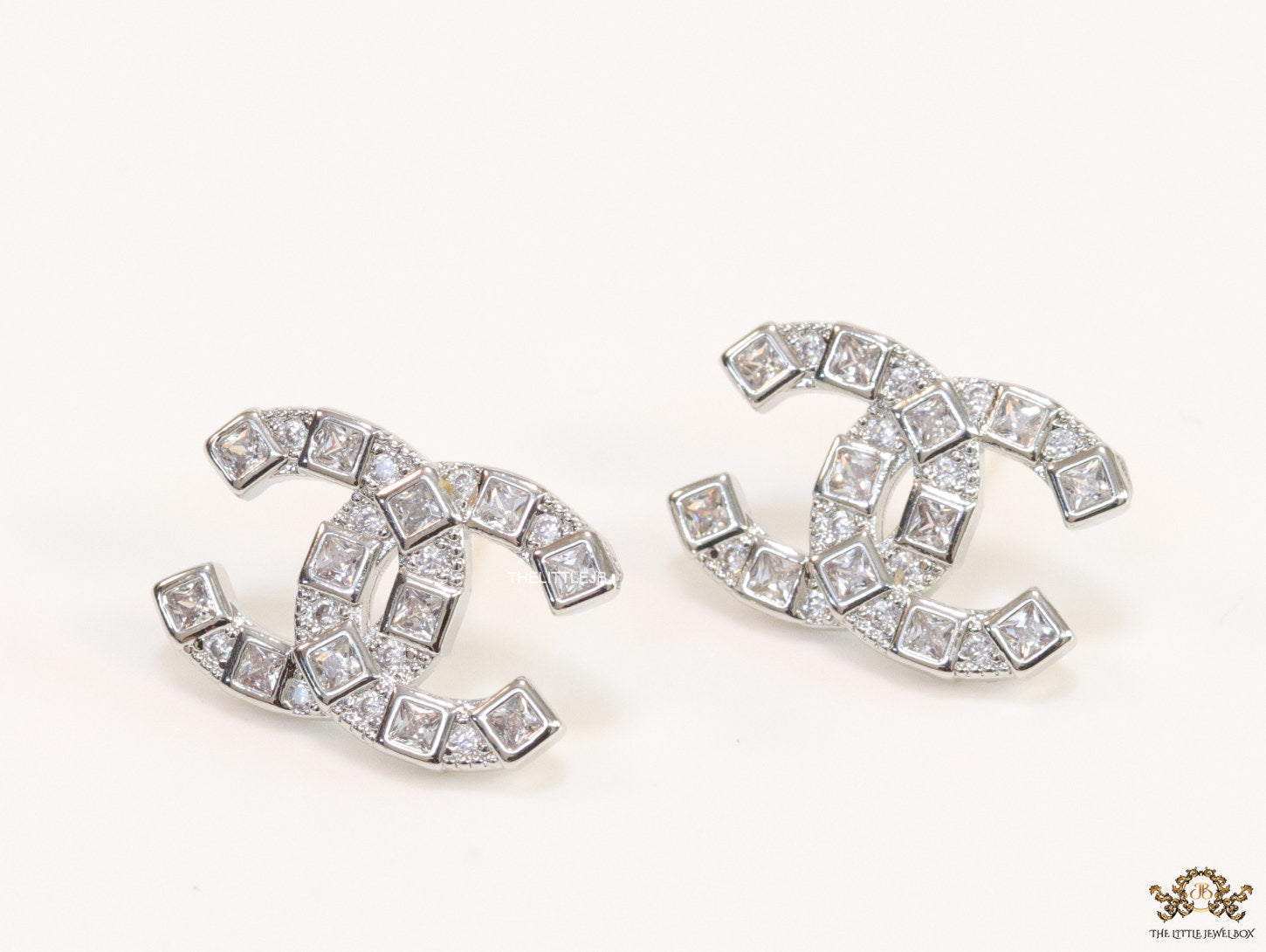 Platinum plated twin C motif studs with fancy cut cz