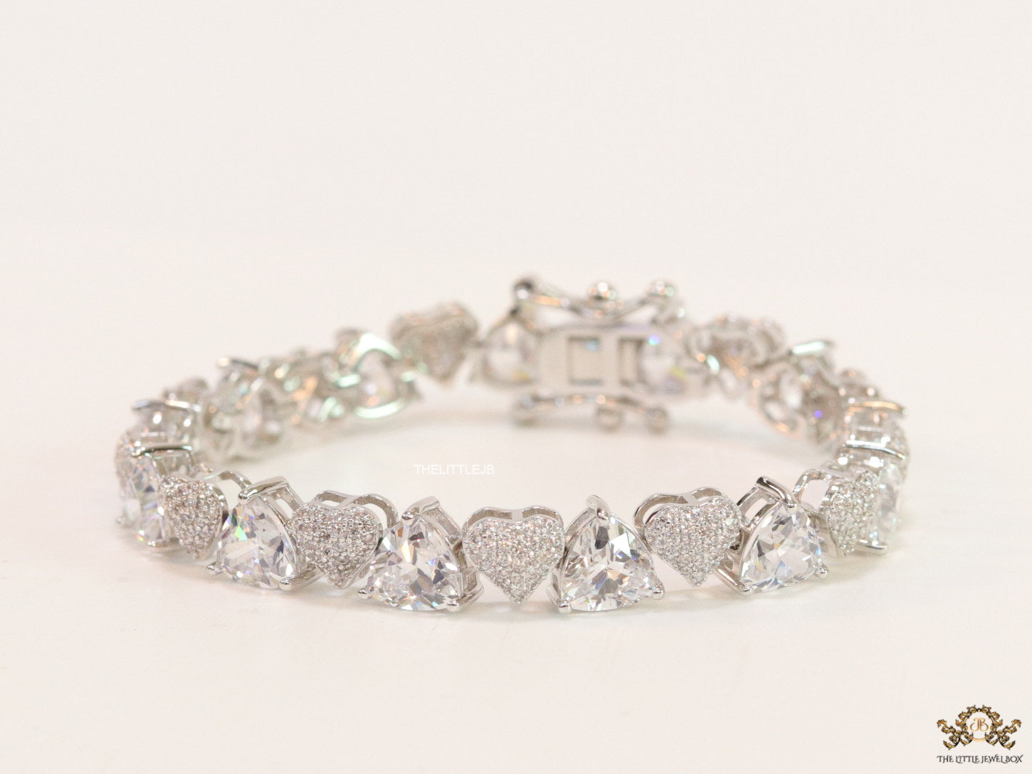 Fancy cut triangle and heart shape cz bracelet in platinum finish