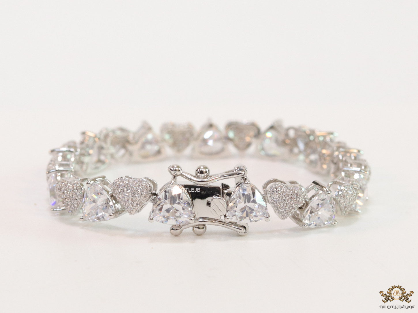 Fancy cut triangle and heart shape cz bracelet in platinum finish