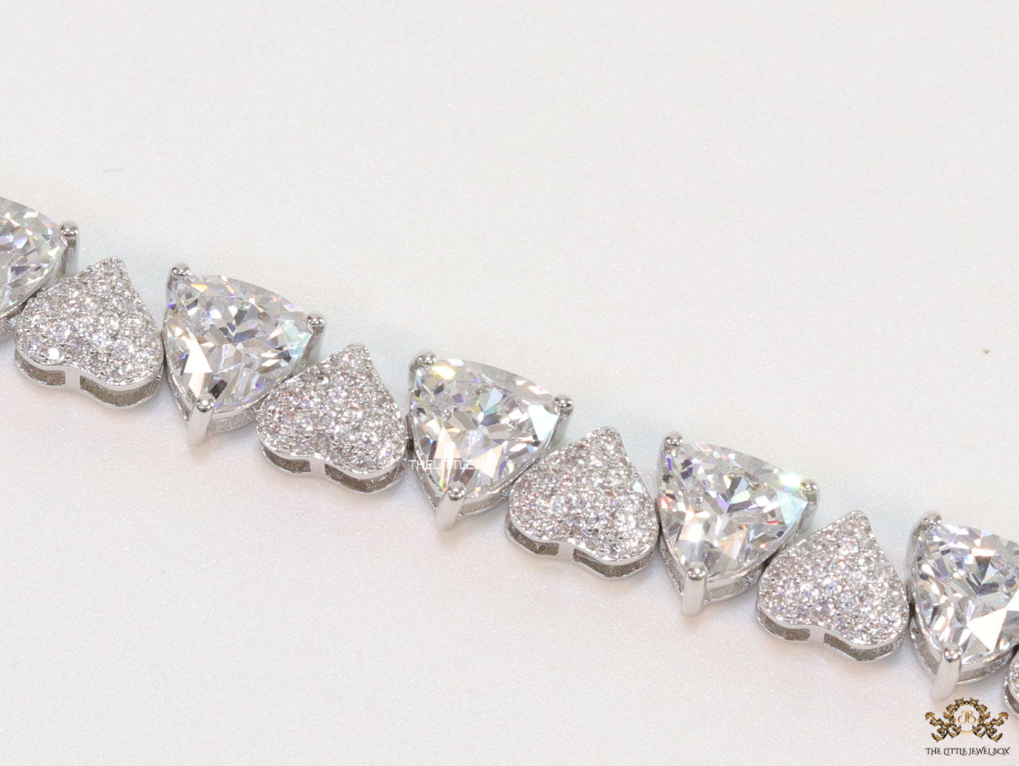 Fancy cut triangle and heart shape cz bracelet in platinum finish