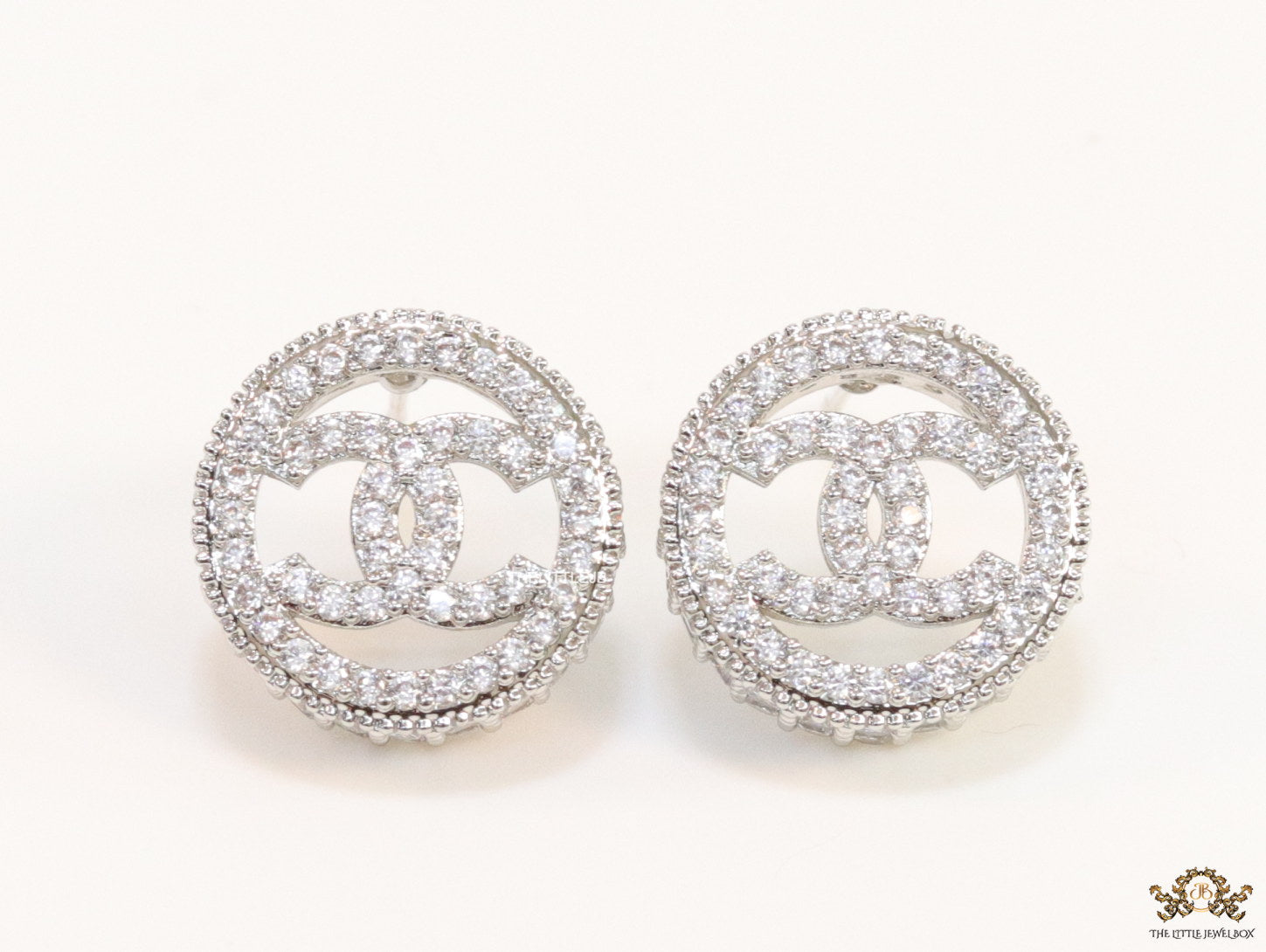 Round platinum studs lined with cz and twin C motif centre