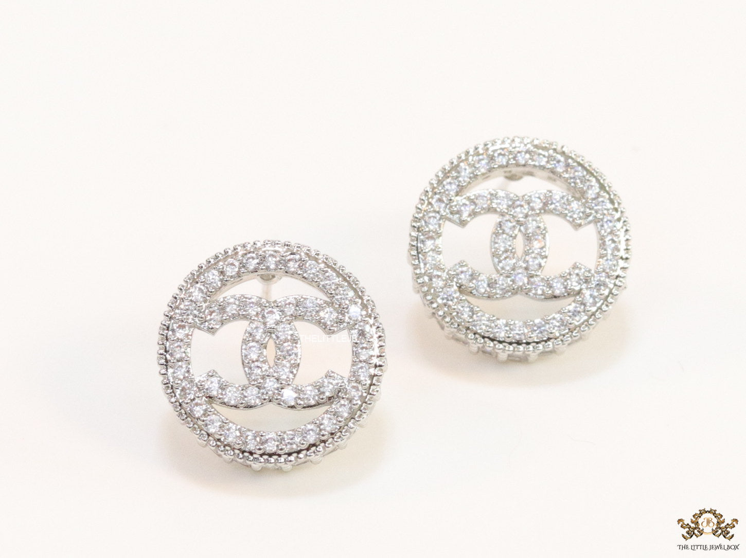 Round platinum studs lined with cz and twin C motif centre