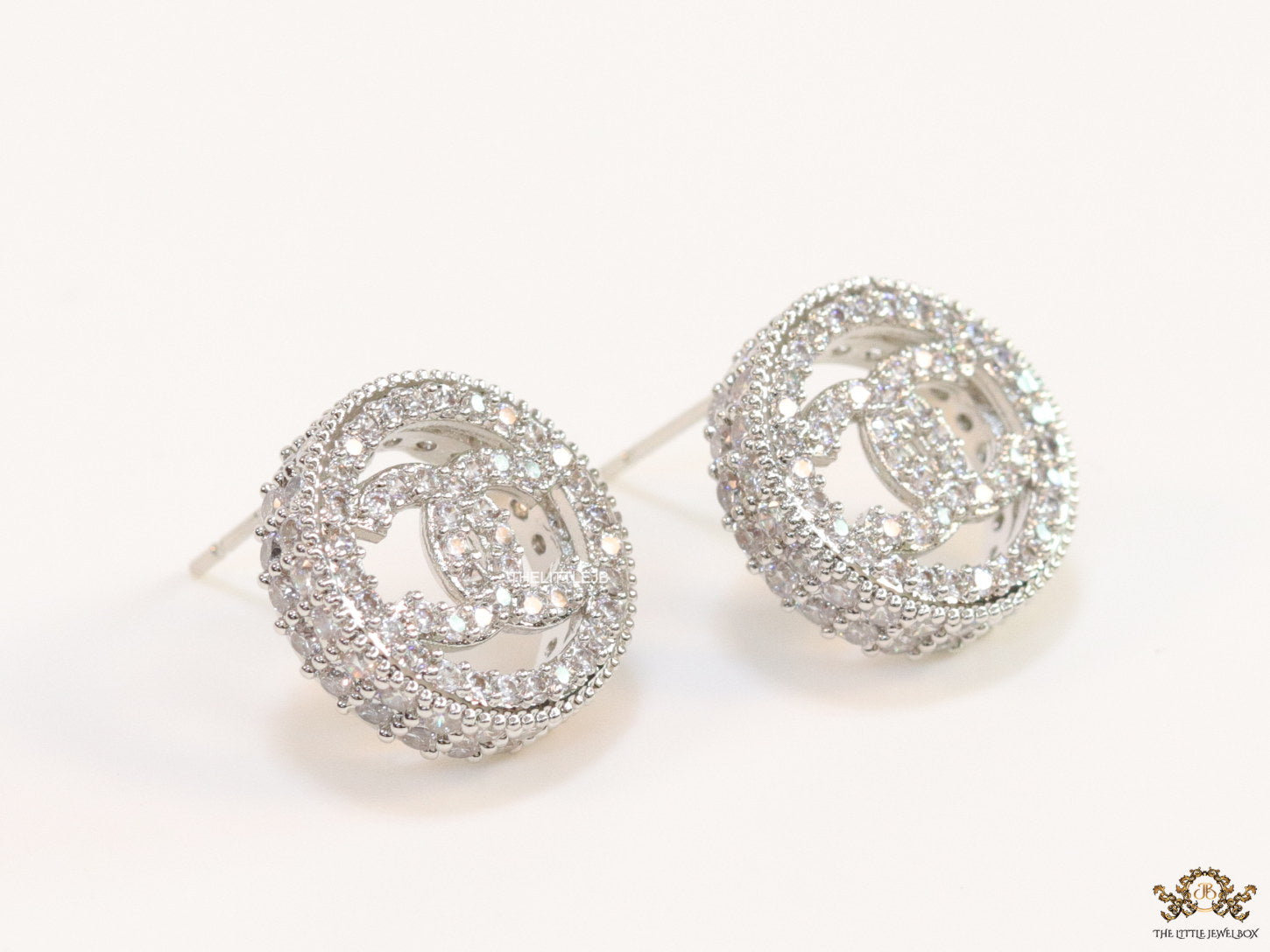 Round platinum studs lined with cz and twin C motif centre