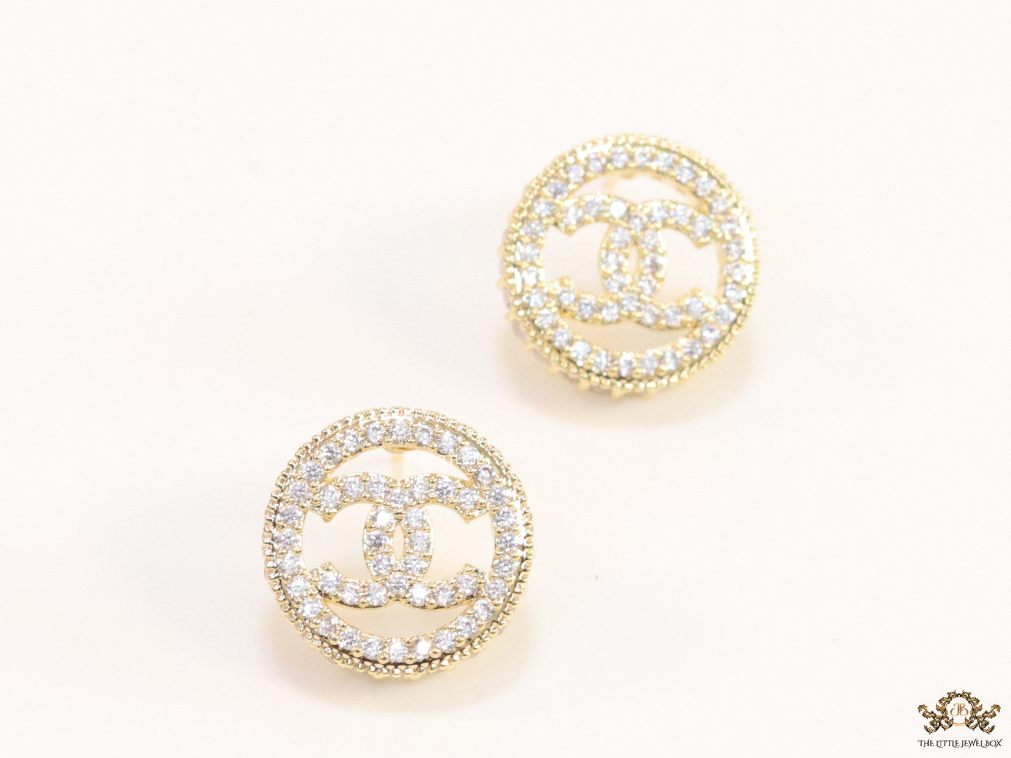 Round golden studs lined with cz and twin C motif centre
