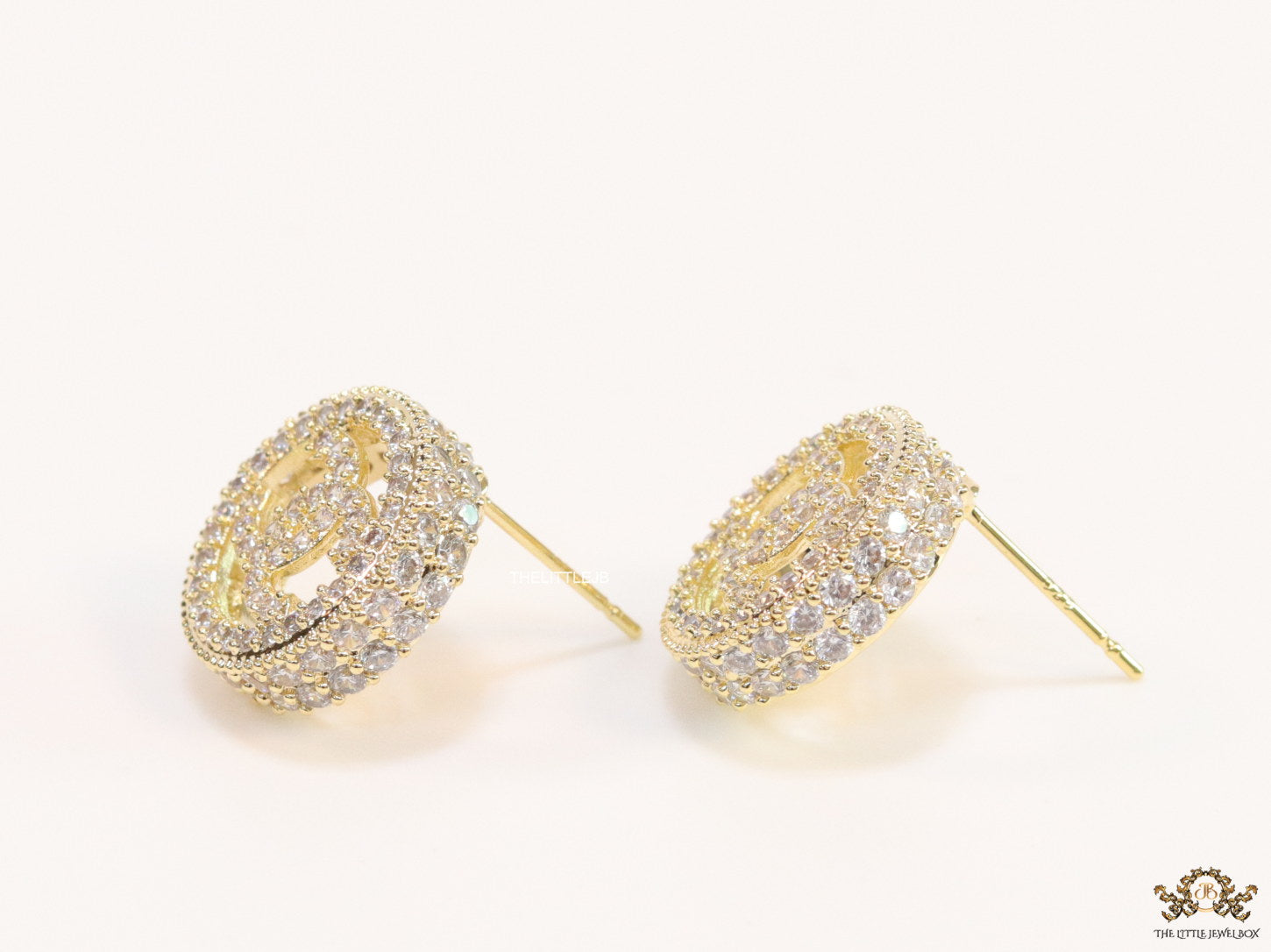 Round golden studs lined with cz and twin C motif centre
