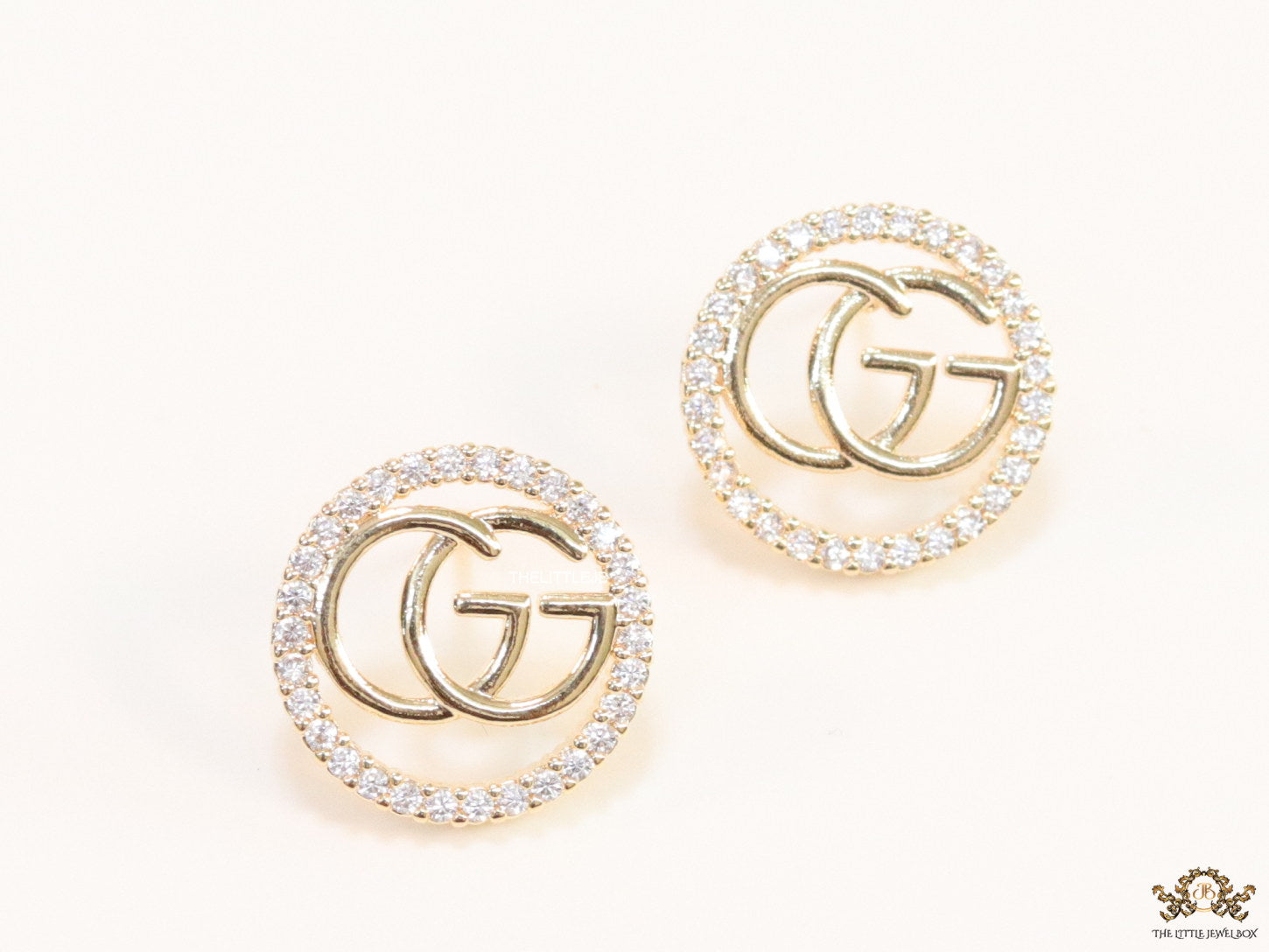Gold plated round cz earrings with twin G motif