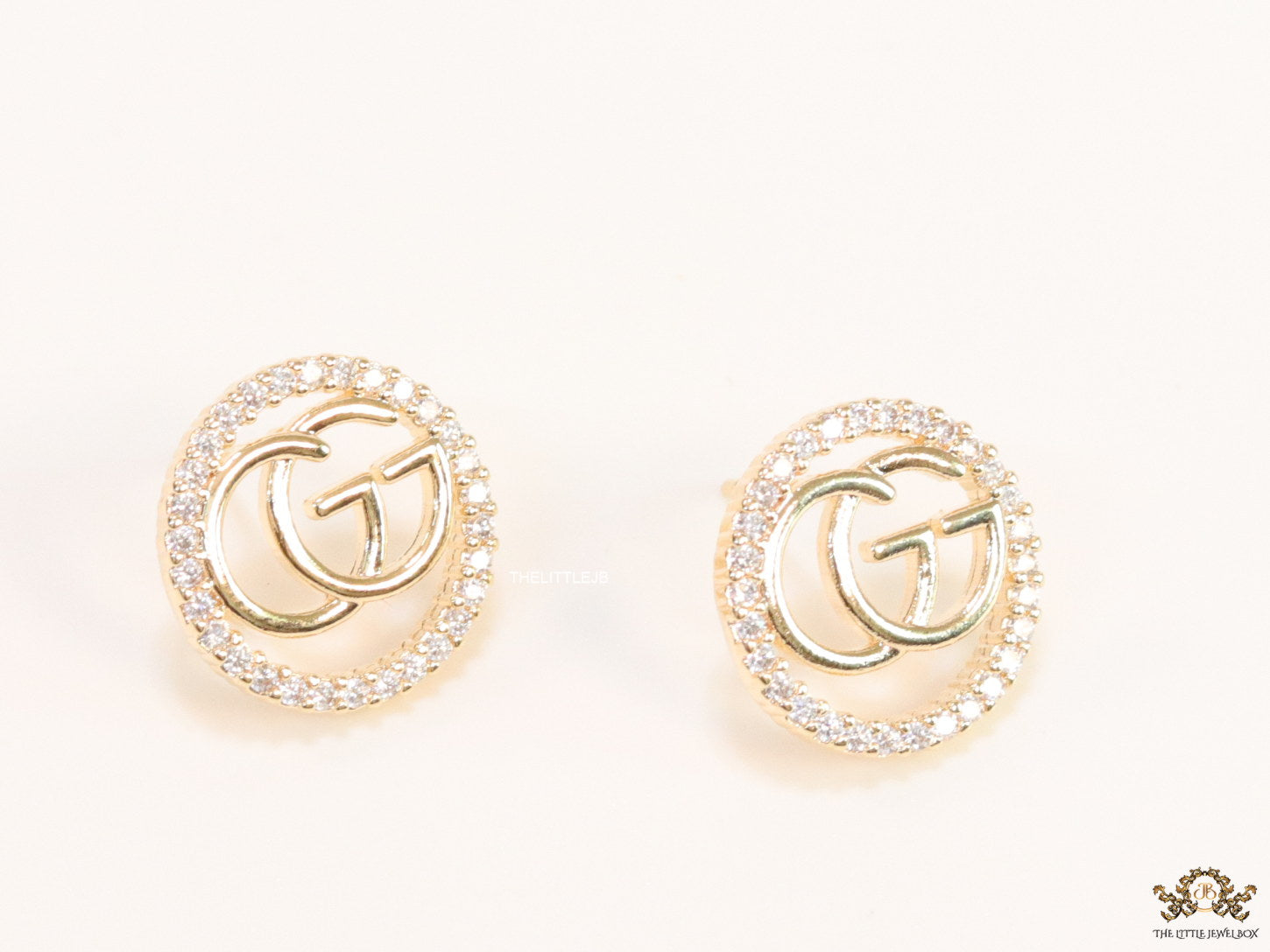 Gold plated round cz earrings with twin G motif