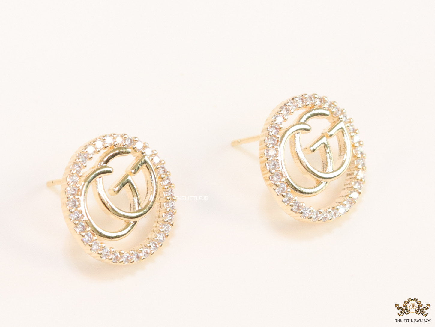 Gold plated round cz earrings with twin G motif