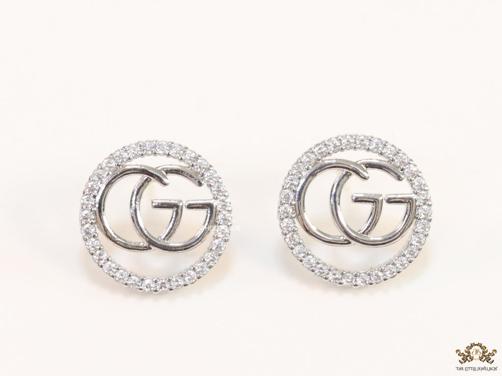Platinum plated round cz earrings with twin G motif