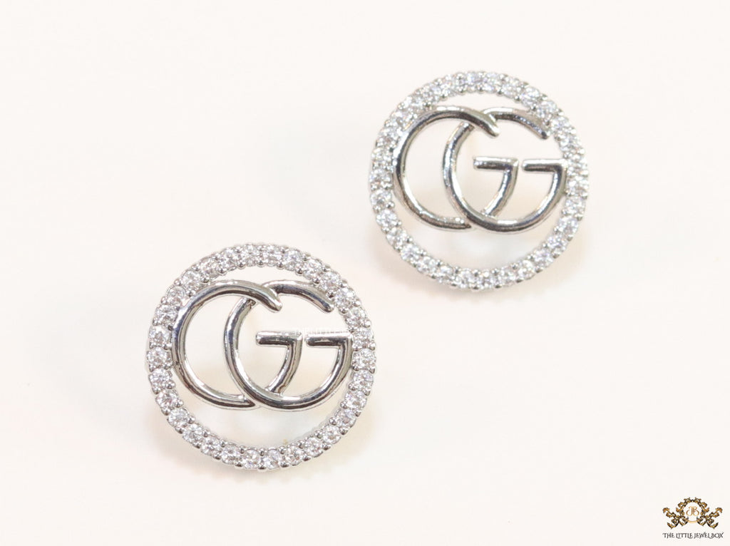 Platinum plated round cz earrings with twin G motif