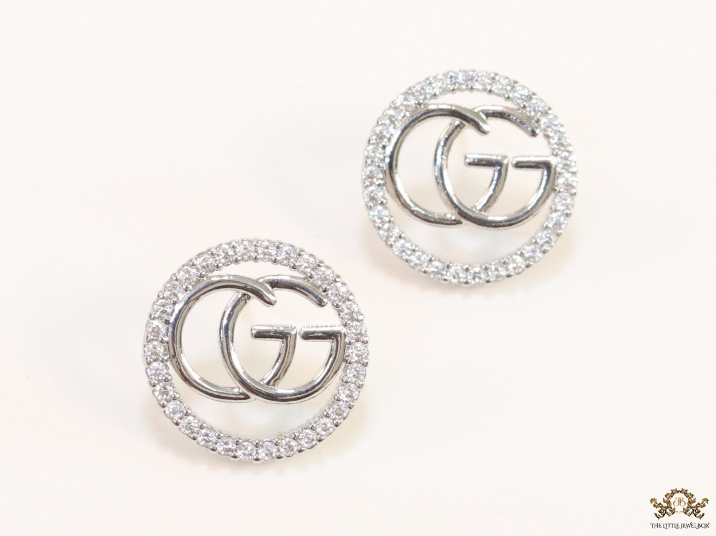 Platinum plated round cz earrings with twin G motif
