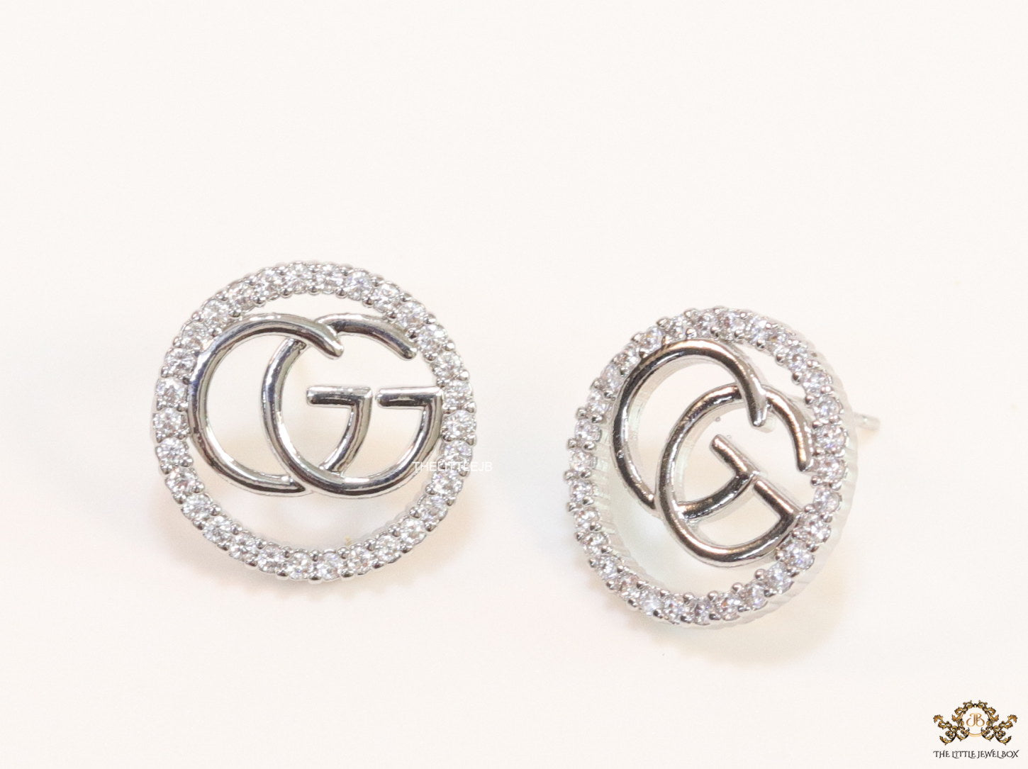 Platinum plated round cz earrings with twin G motif