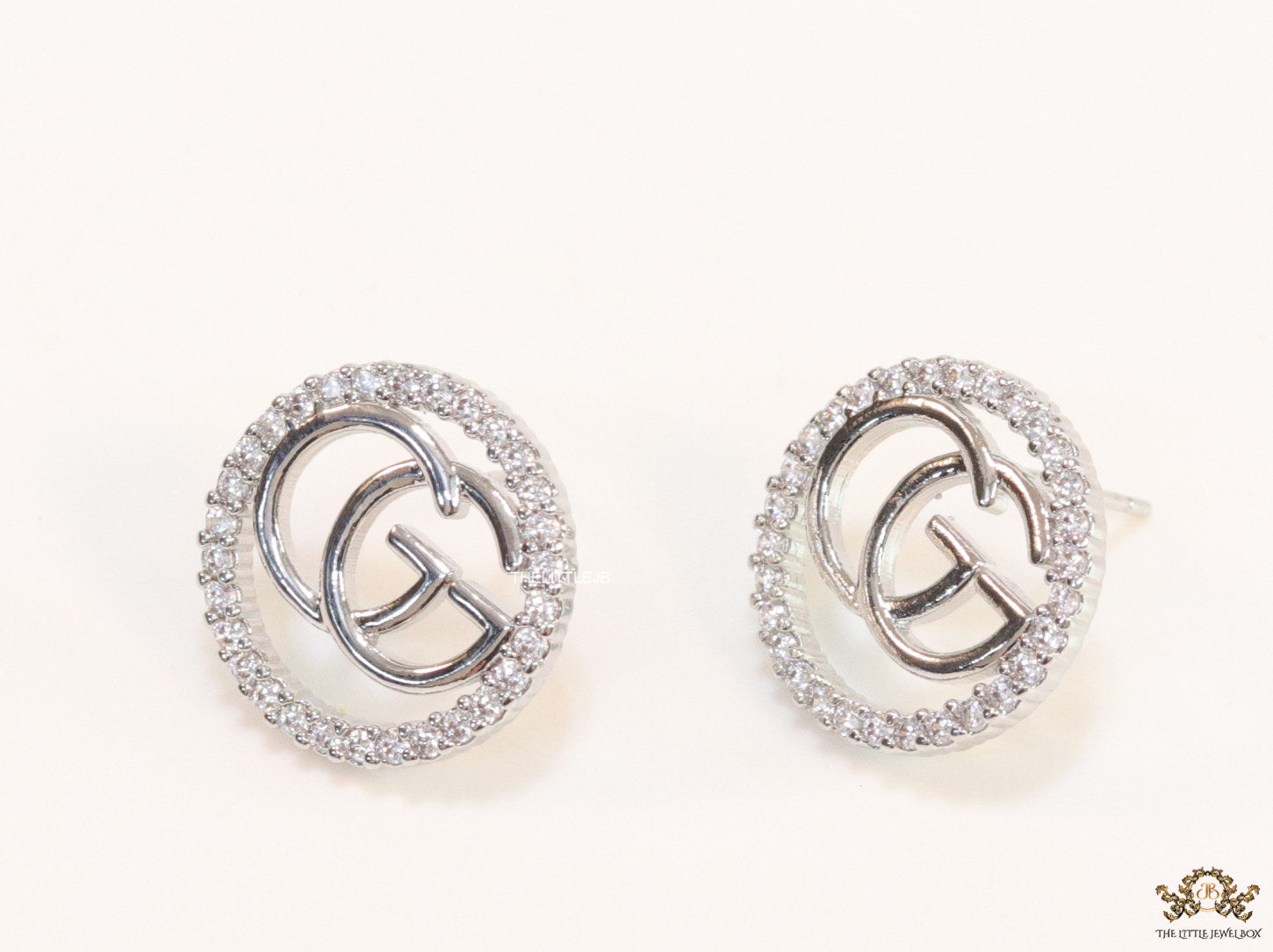 Platinum plated round cz earrings with twin G motif