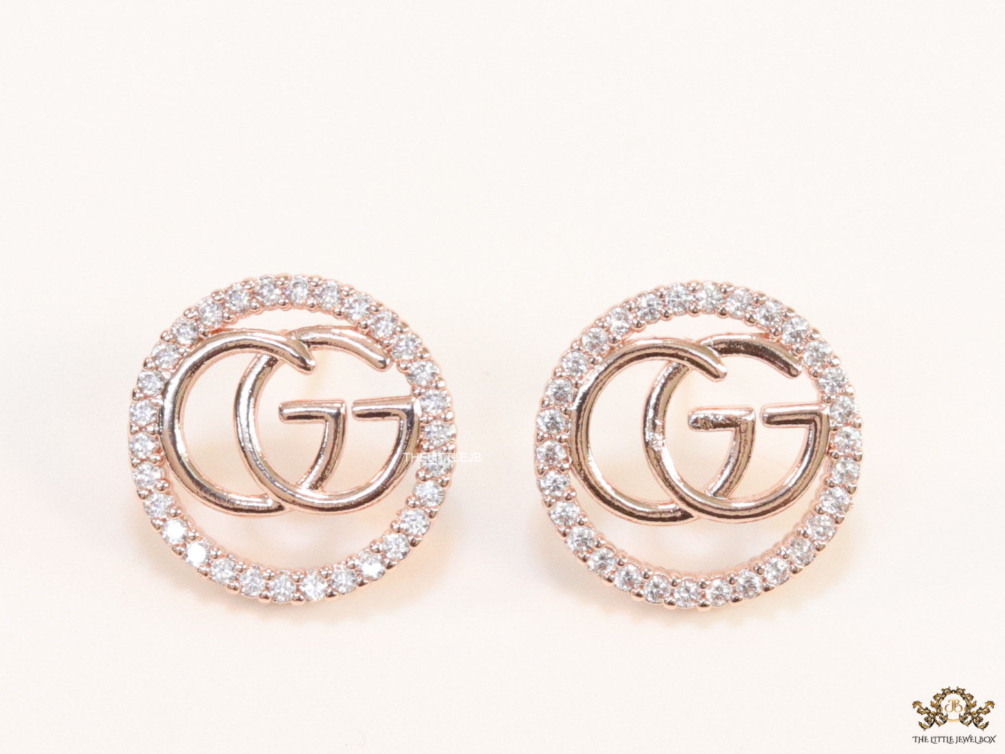 Rose gold plated round cz earrings with twin G motif
