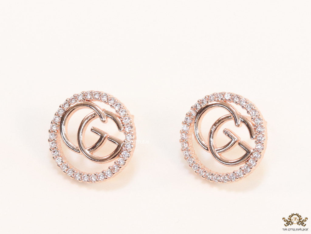 Rose gold plated round cz earrings with twin G motif