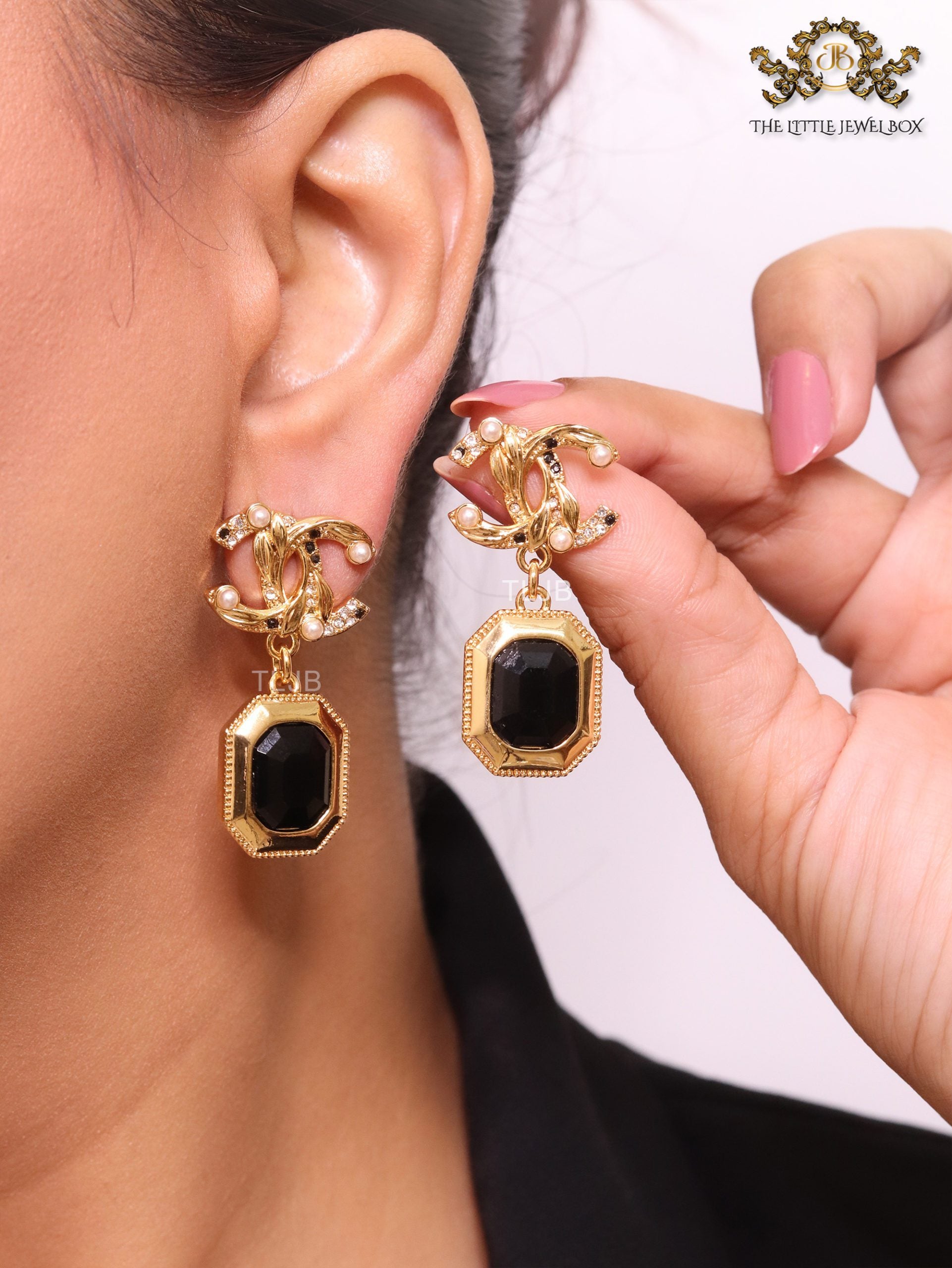 Gold Double C earrings with black enamel hanging