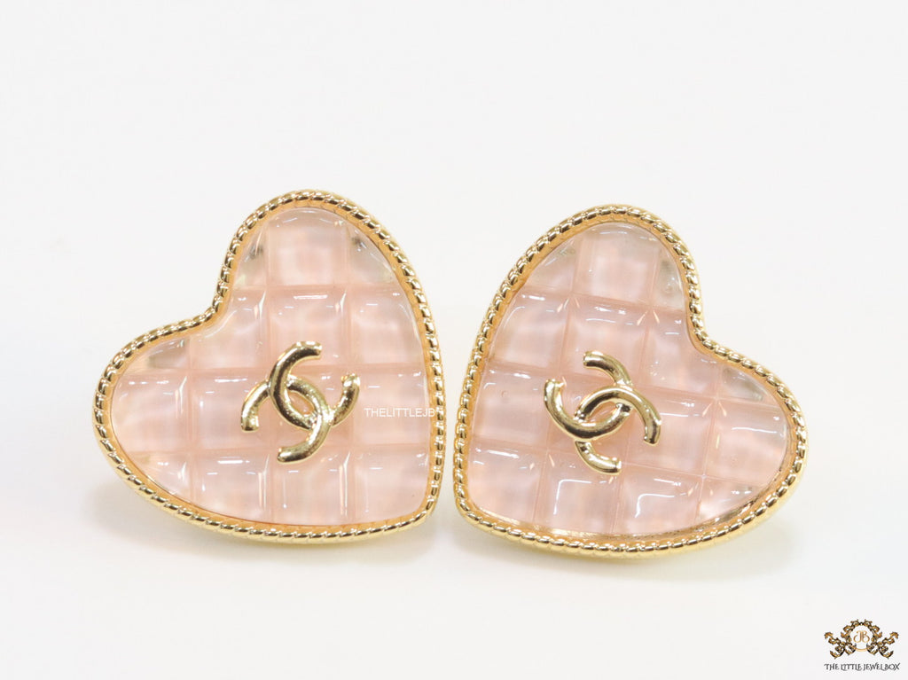 Light pink textured heart shaped studs with twin C motif in golden finish