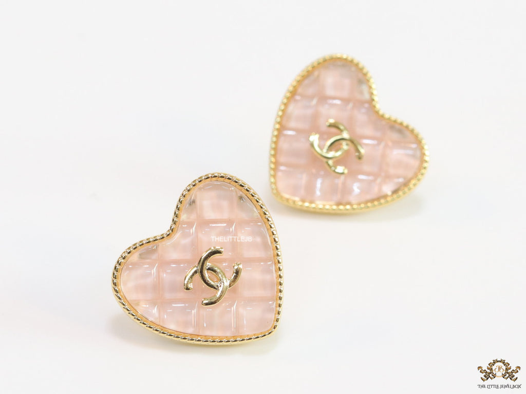 Light pink textured heart shaped studs with twin C motif in golden finish
