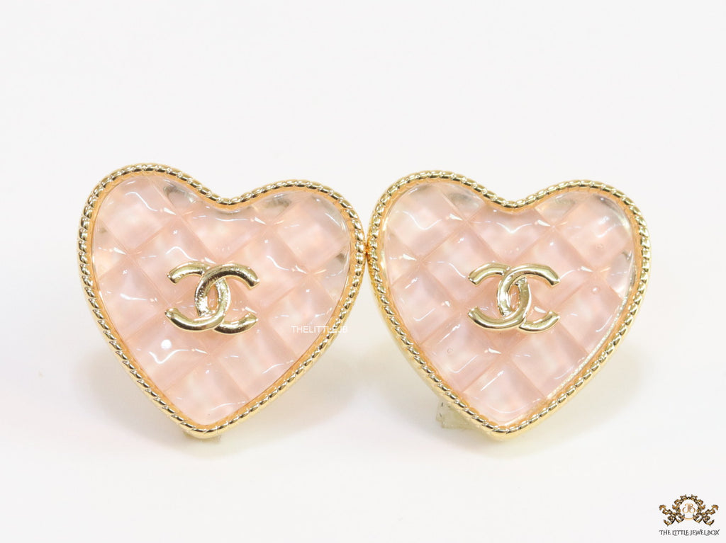 Light pink textured heart shaped studs with twin C motif in golden finish