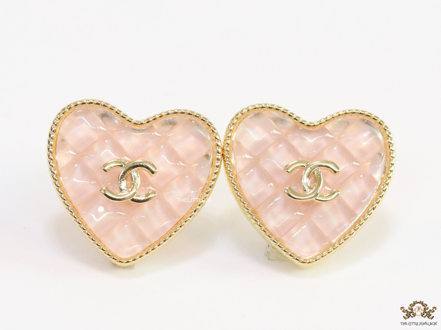 Light pink textured heart shaped studs with twin C motif in golden finish