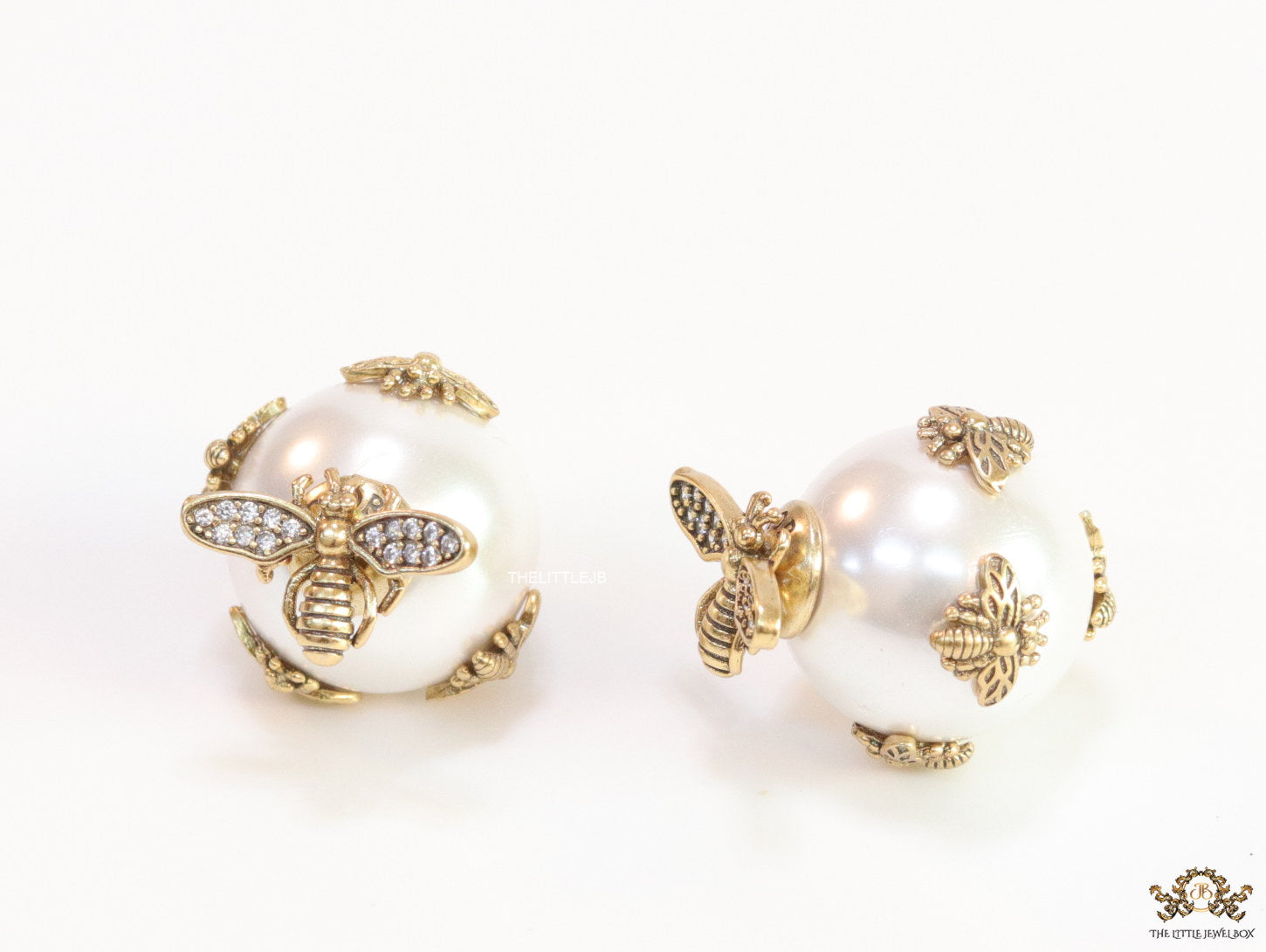 Designer pearl earrings with matte gold flying bee motifs