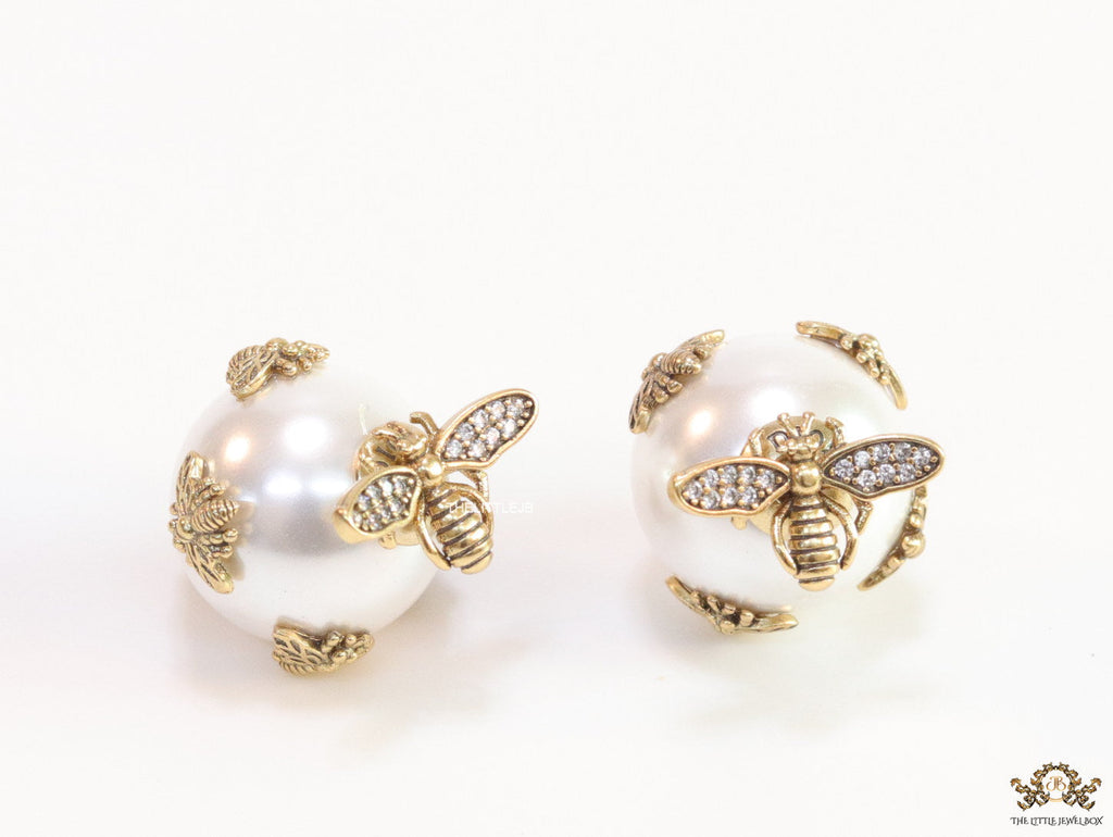 Designer pearl earrings with matte gold flying bee motifs