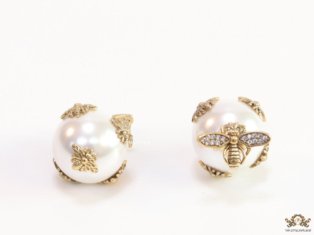 Designer pearl earrings with matte gold flying bee motifs