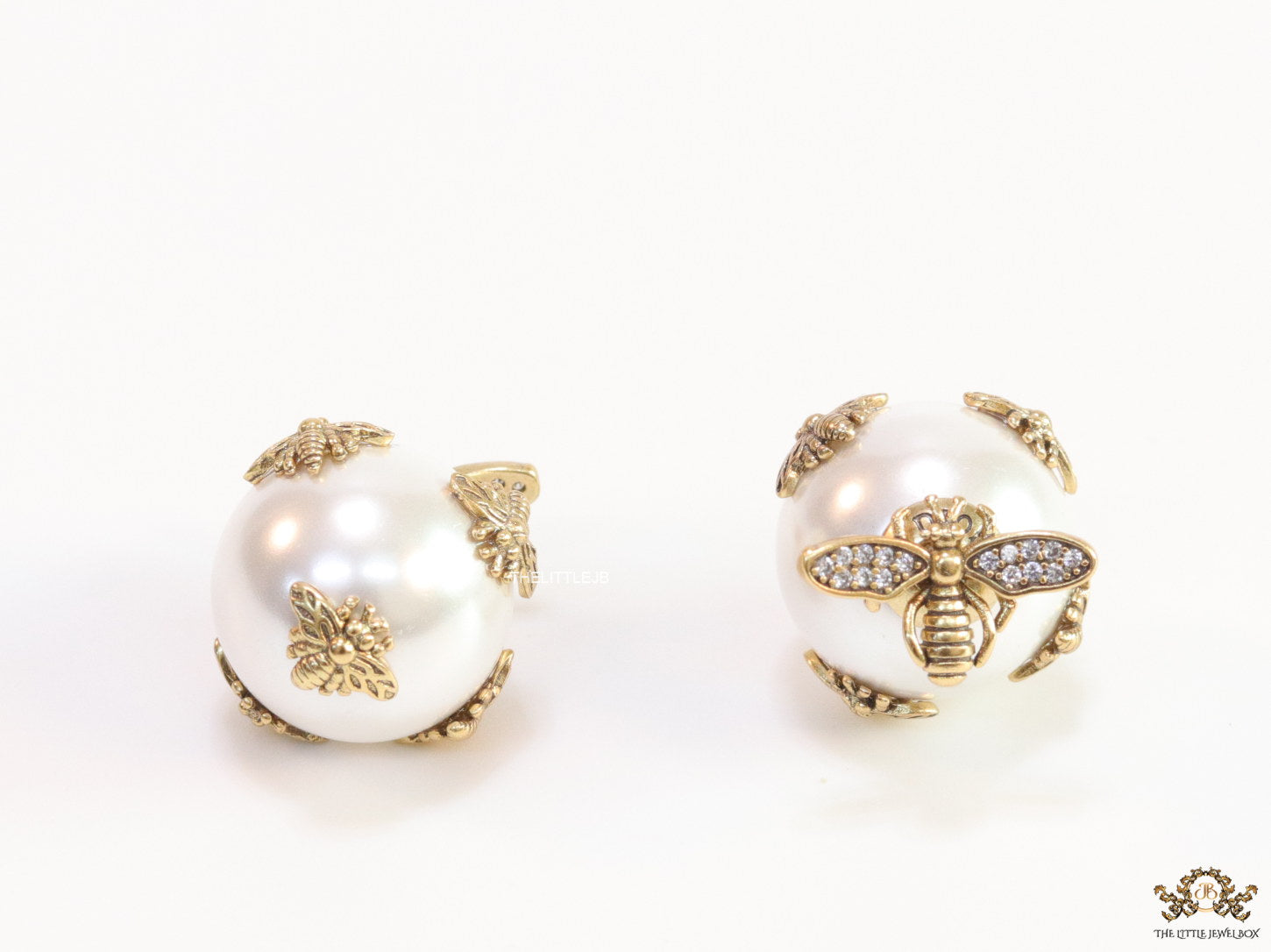 Designer pearl earrings with matte gold flying bee motifs