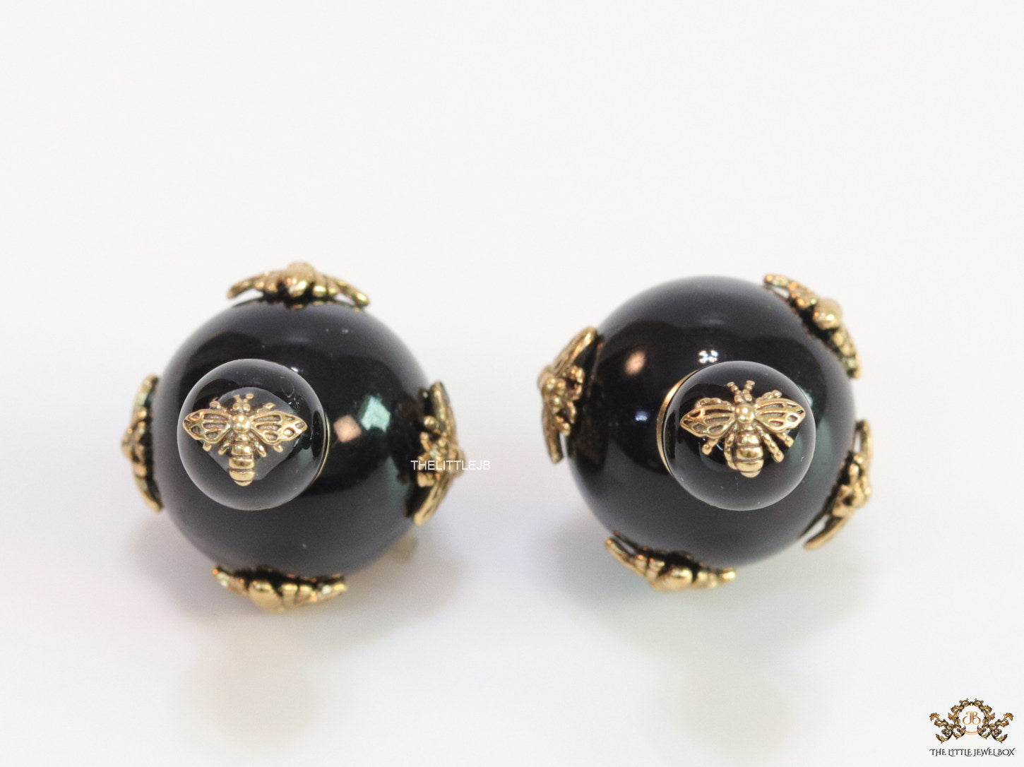 Designer pearl earrings with matte gold flying bee motifs