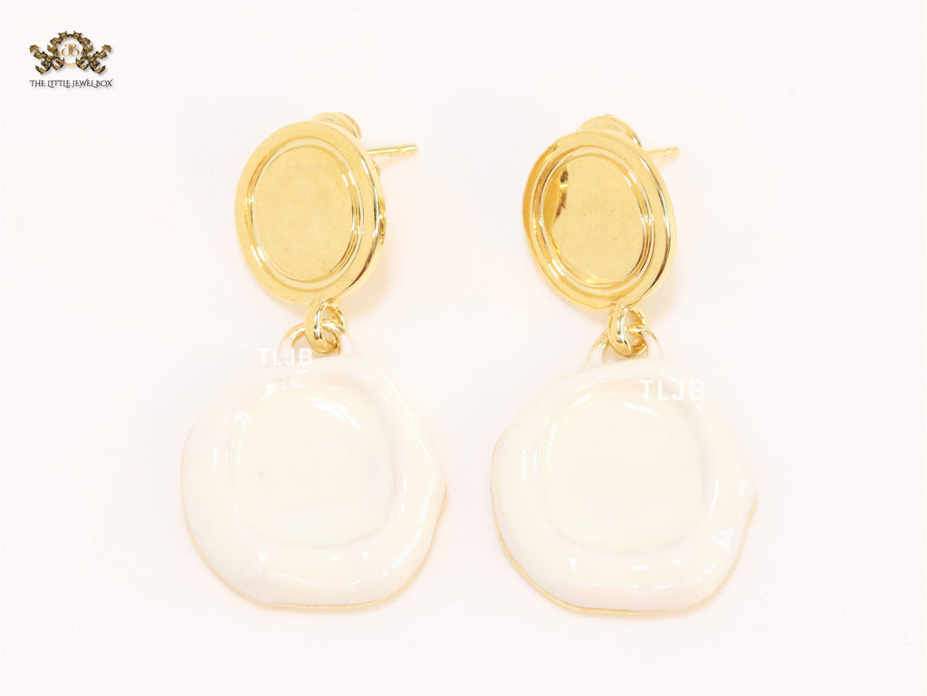 White enamel and gold earrings