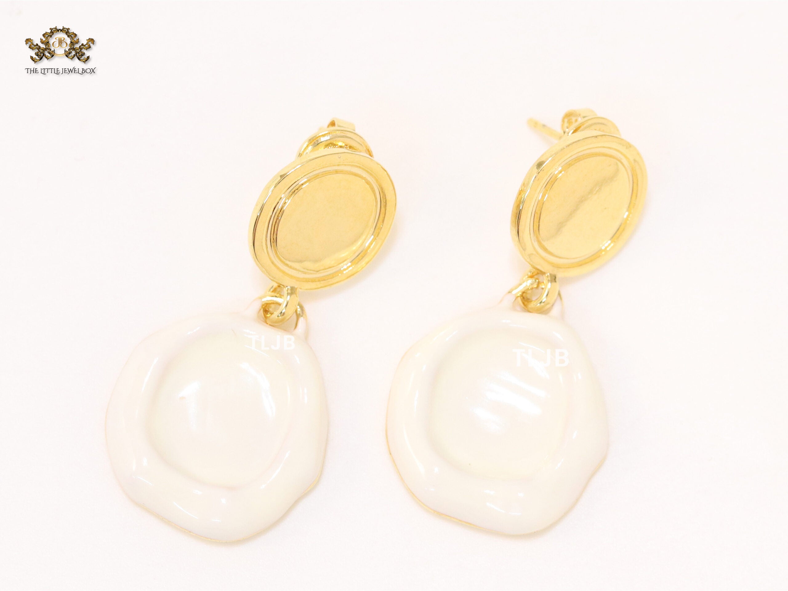 White enamel and gold earrings