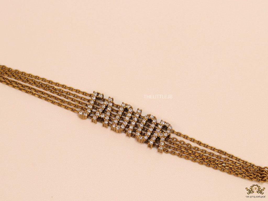 Multichain bracelet with cz alphabets in antique gold finish