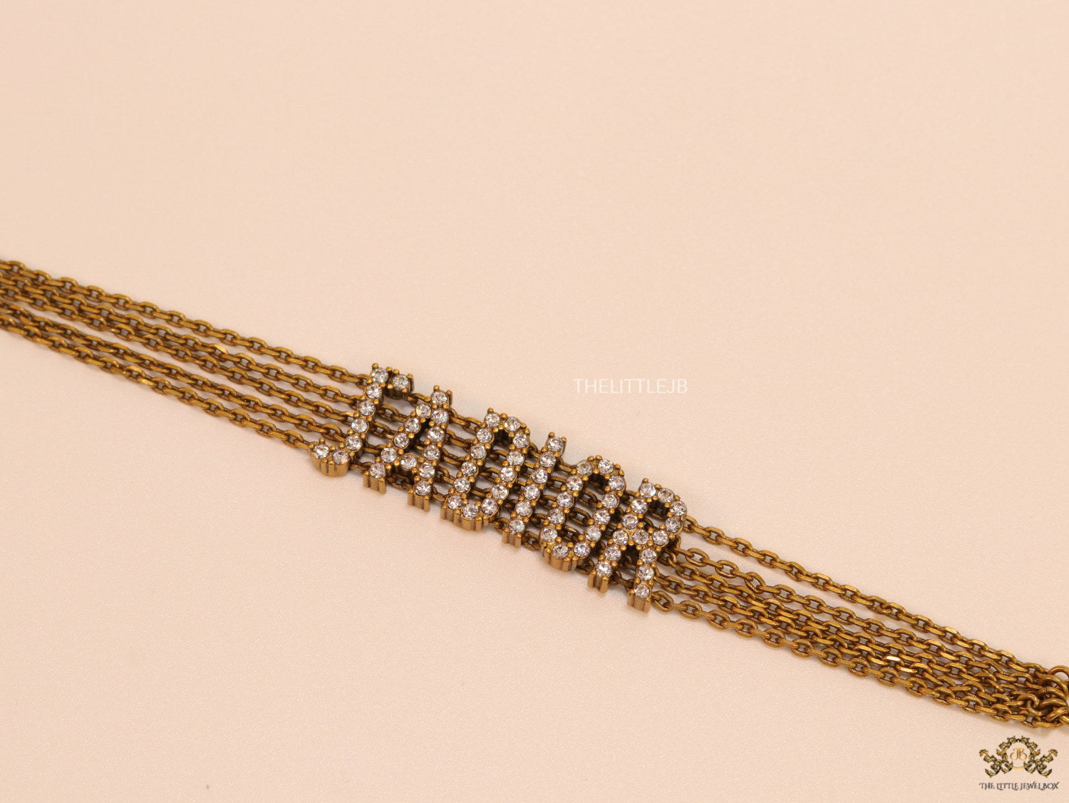 Multichain bracelet with cz alphabets in antique gold finish