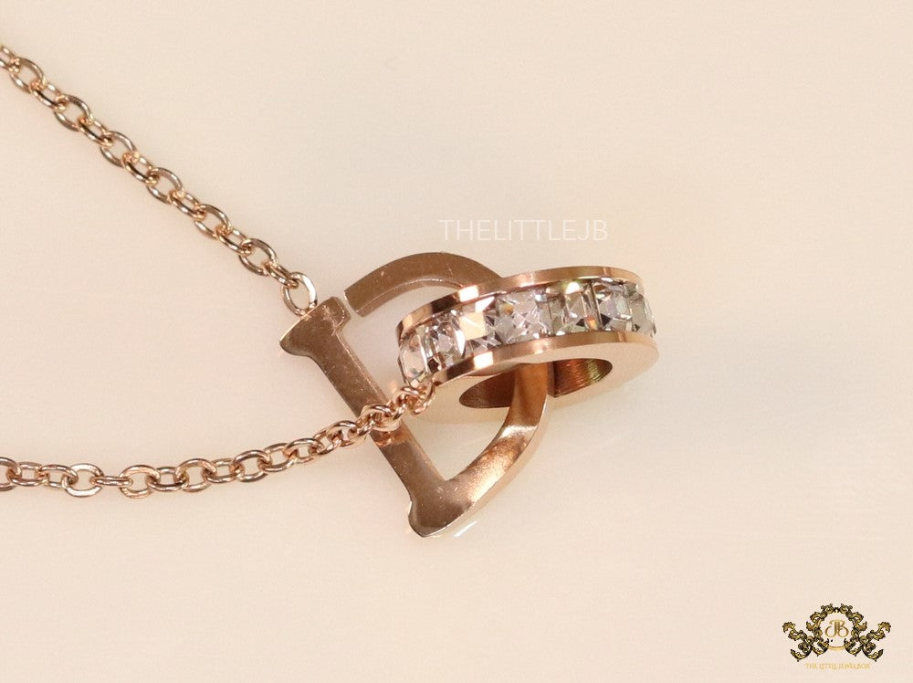 Rose gold plated D initial necklace with interlocking cz ring