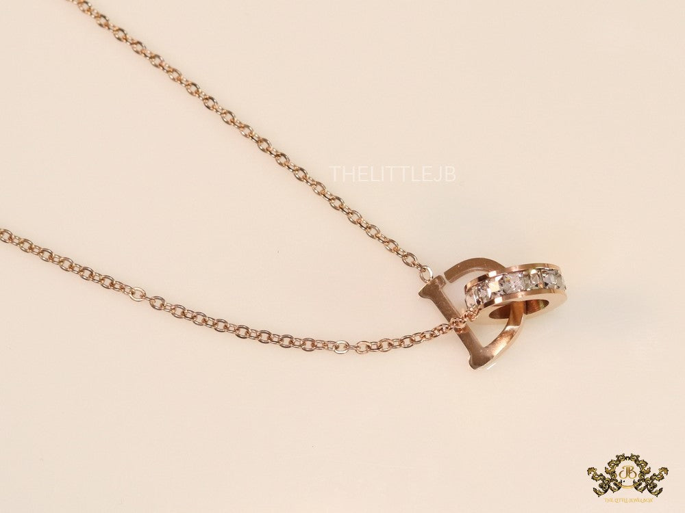 Rose gold plated D initial necklace with interlocking cz ring