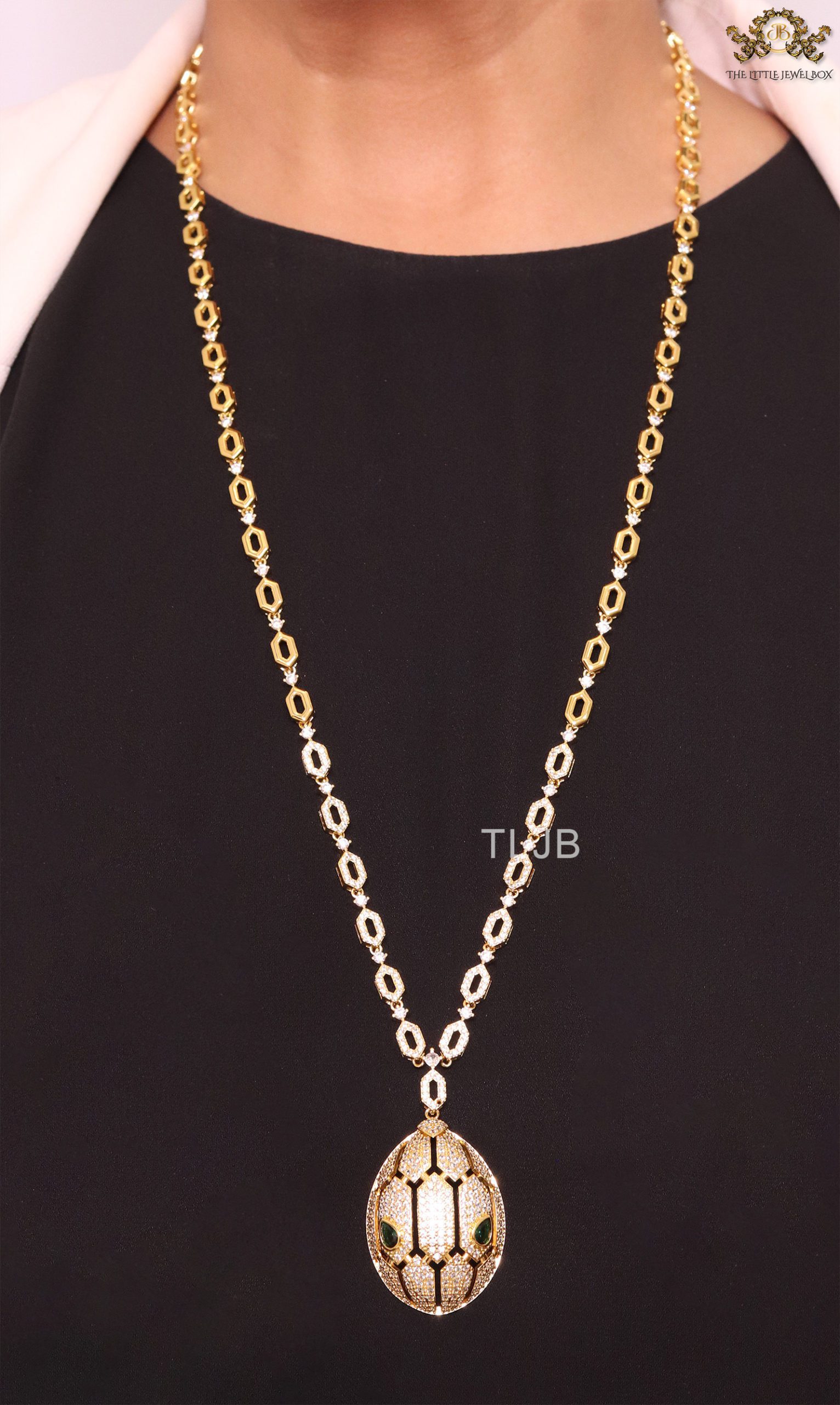 Gold Snake head pendant set with emerald detailing