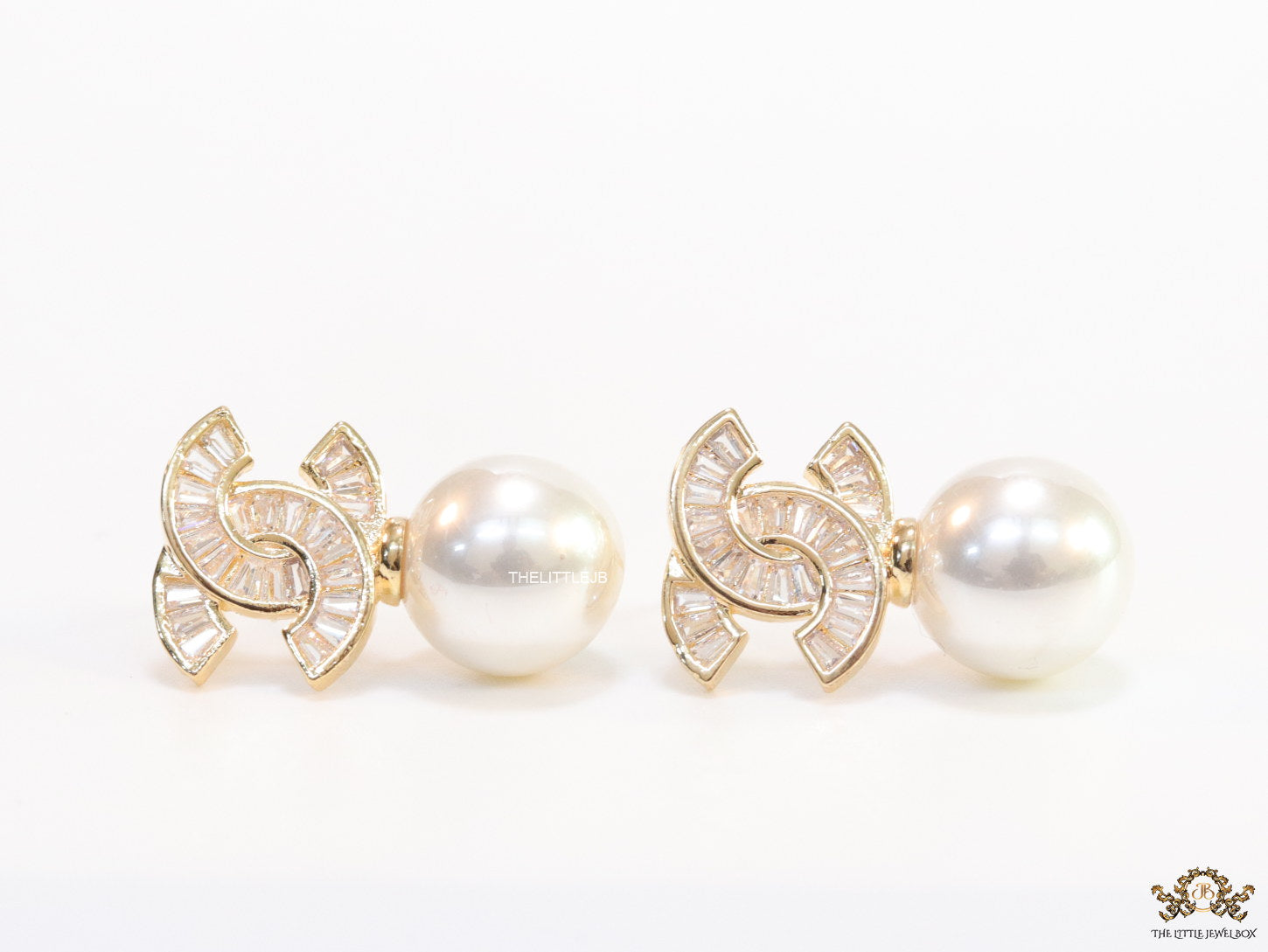 Golden cz baguettes studded twin C motif stud with pearl drop