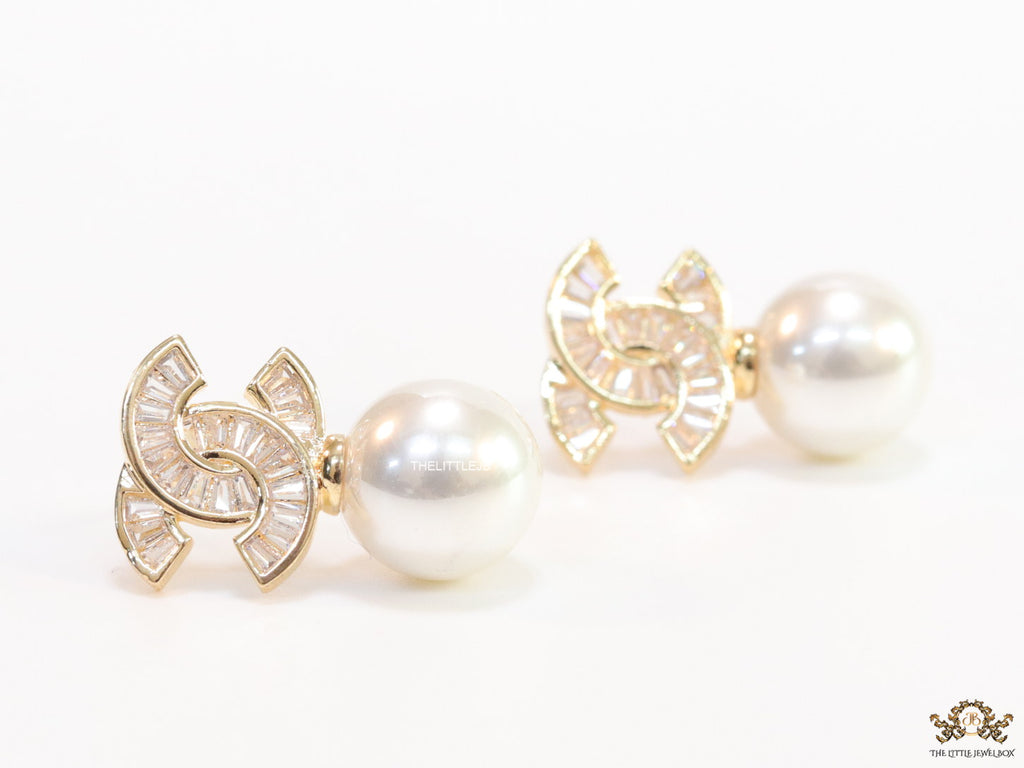 Golden cz baguettes studded twin C motif stud with pearl drop